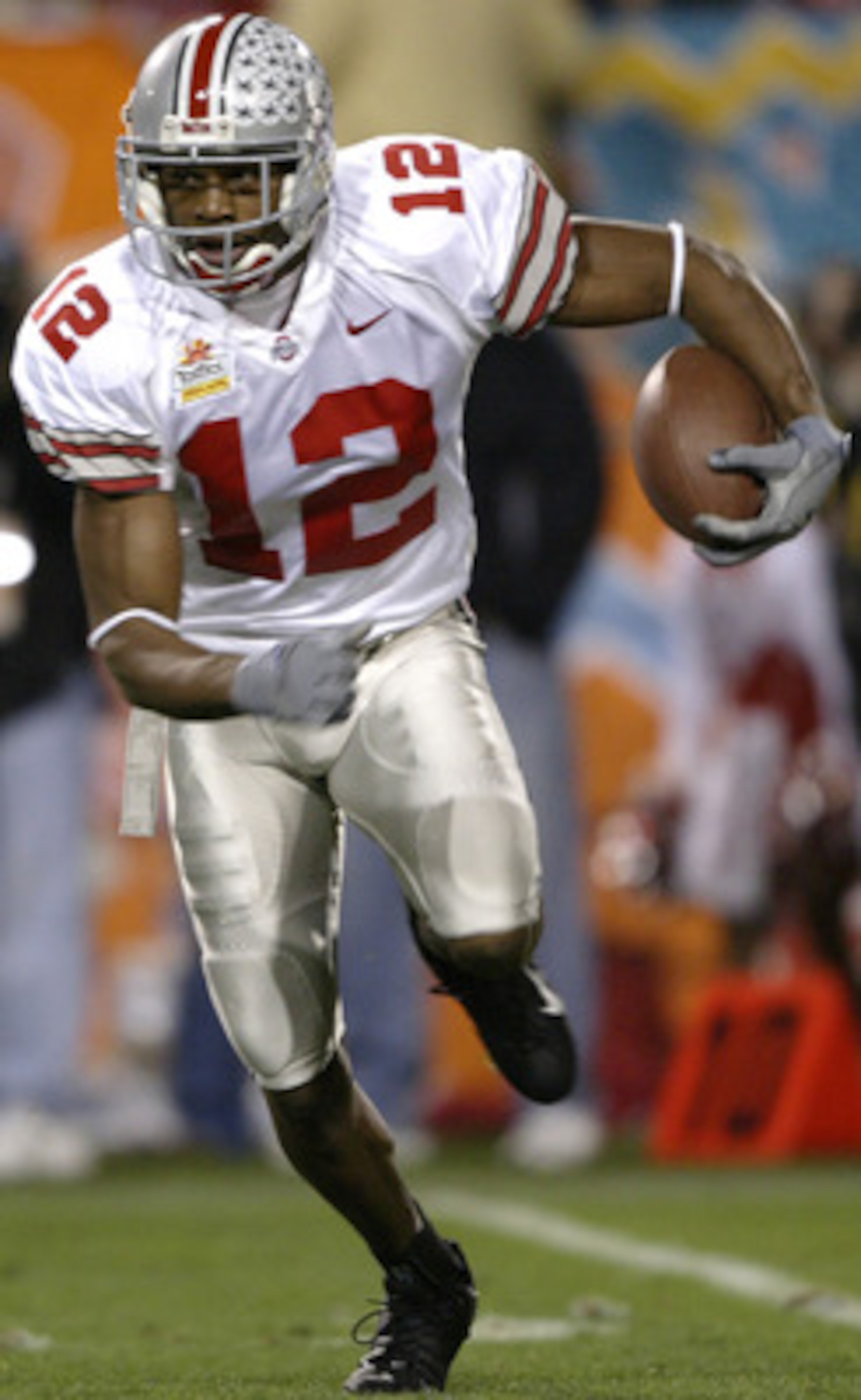 TEMPE, AZ - JANUARY 2: Michael Jenkins #12 of the Ohio State Buckeyes runs against the defense of the Kansas State Wildcats during the first half of the Fiesta Bowl on January 2, 2004 at the Sun Devil Stadium in Tempe, Arizona. (Photo by Elsa/Getty Imag TEMPE, AZ - JANUARY 2: Michael Jenkins #12 of the Ohio State Buckeyes runs against the defense of the Kansas State Wildcats during the first half of the Fiesta Bowl on January 2, 2004 at the Sun Devil Stadium in Tempe, Arizona. (Photo by Elsa/Getty Imag