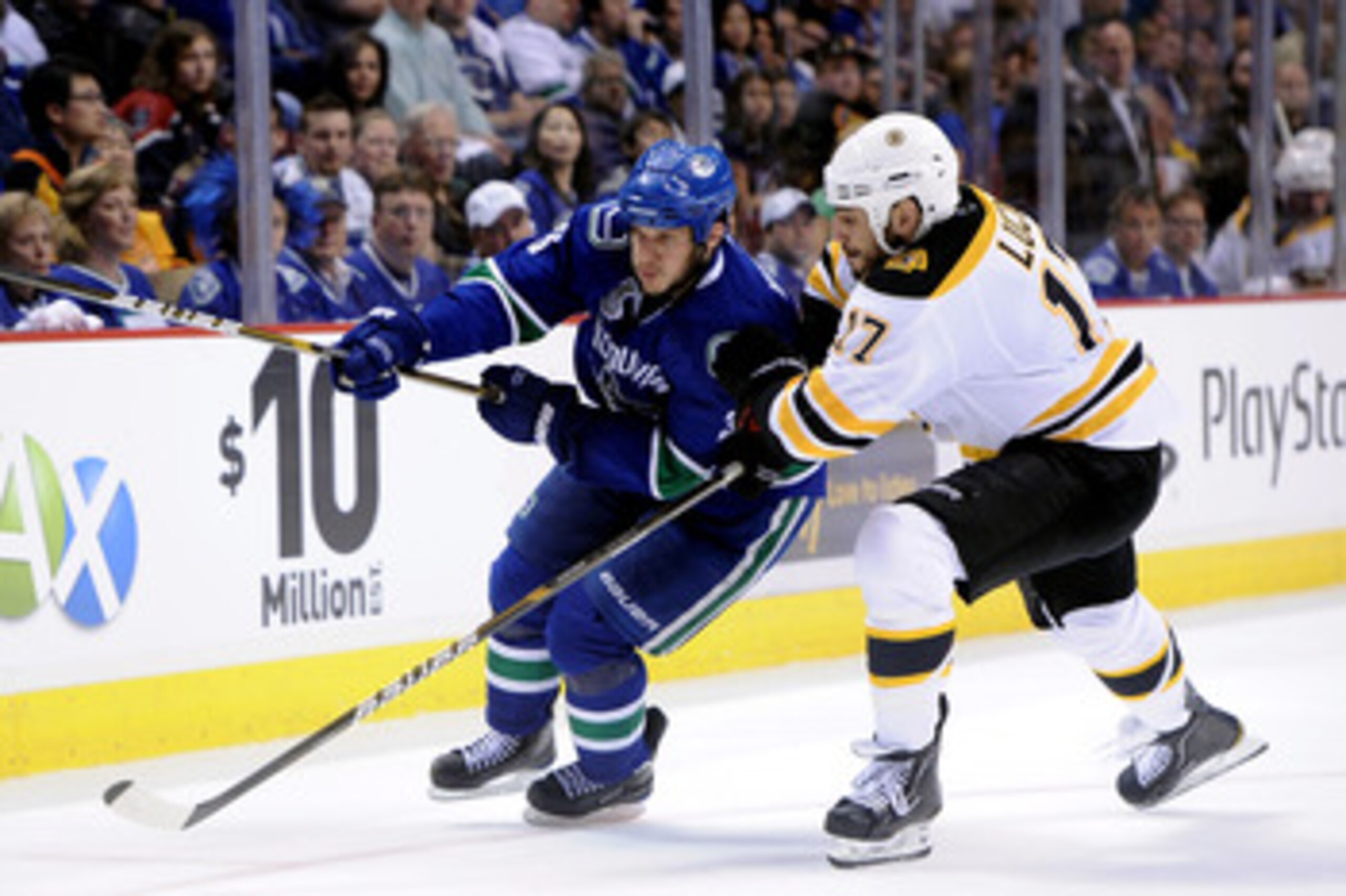 VANCOUVER, BC - JUNE 01:  Kevin Bieksa #3 of the Vancouver Canucks skates against Milan Lucic #17 of the Boston Bruins during game one of the 2011 NHL Stanley Cup Finals at Rogers Arena on June 1, 2011 in Vancouver, Canada.  (Photo by Harry How/Getty Imag