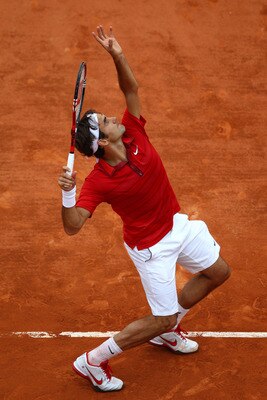 PARIS, FRANCE - JUNE 03:  Roger Federer of Switzerland serves during the men's singles semi final match between Roger Federer of Switzerland and Novak Djokovic of Serbia on day thirteen of the French Open at Roland Garros on June 3, 2011 in Paris, France.