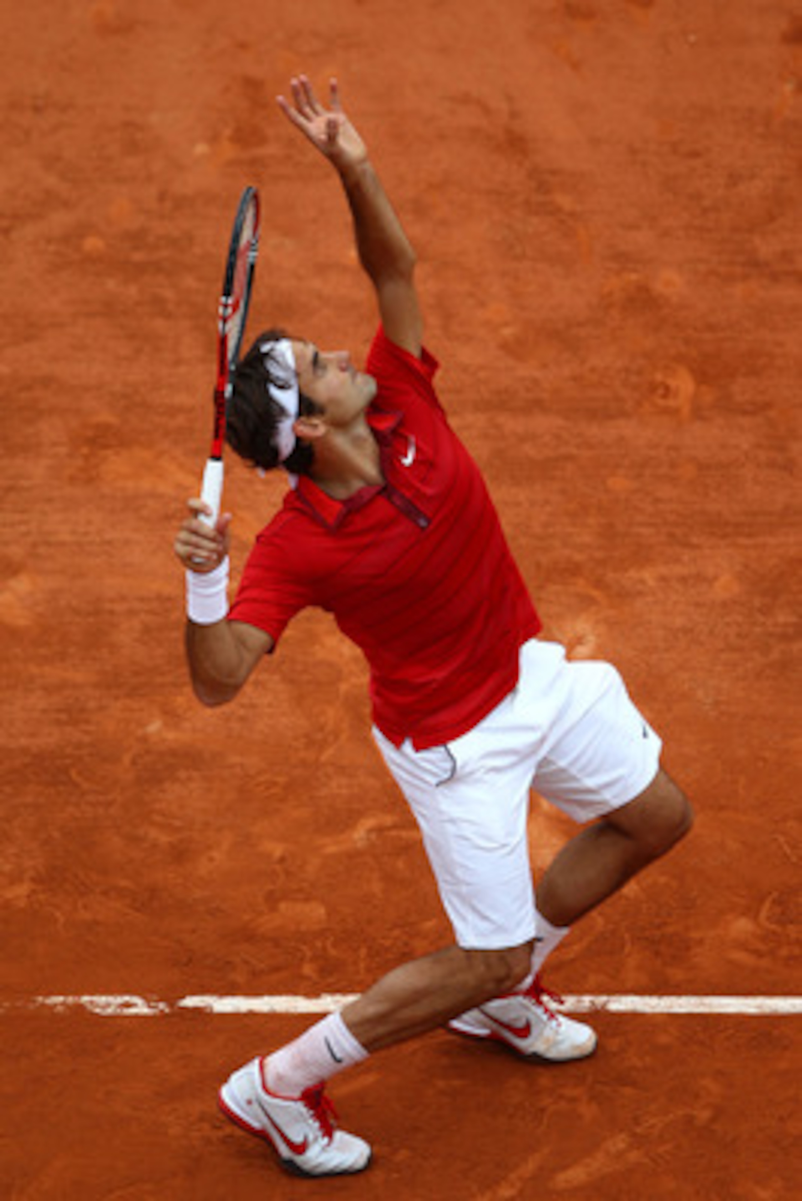 PARIS, FRANCE - JUNE 03:  Roger Federer of Switzerland serves during the men's singles semi final match between Roger Federer of Switzerland and Novak Djokovic of Serbia on day thirteen of the French Open at Roland Garros on June 3, 2011 in Paris, France.