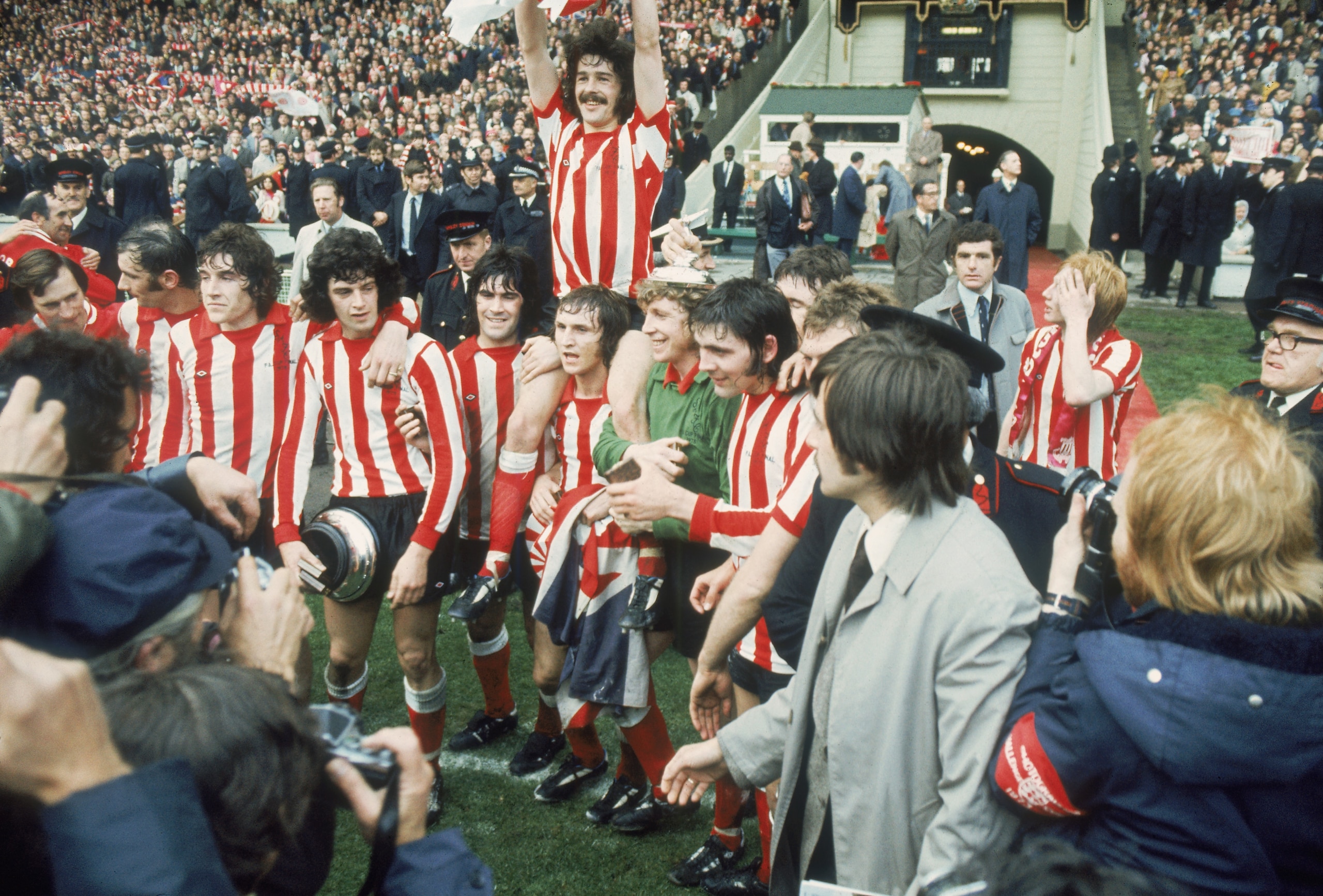 LONDON - MAY 5:  Bobby Kerr of Sunderland lifts the cup as he is lifted up by his team-mates after the FA Cup Final between Sunderland and Leeds United held on May 5, 1973 at Wembley Stadium, in London. Sunderland won the match and cup 1-0. (Photo by Gett