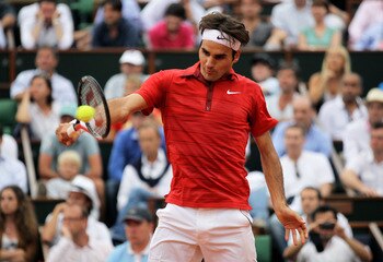 PARIS, FRANCE - JUNE 03:  Roger Federer of Switzerland hits a backhand during the men's singles semi final match between Roger Federer of Switzerland and Novak Djokovic of Serbia on day thirteen of the French Open at Roland Garros on June 3, 2011 in Paris