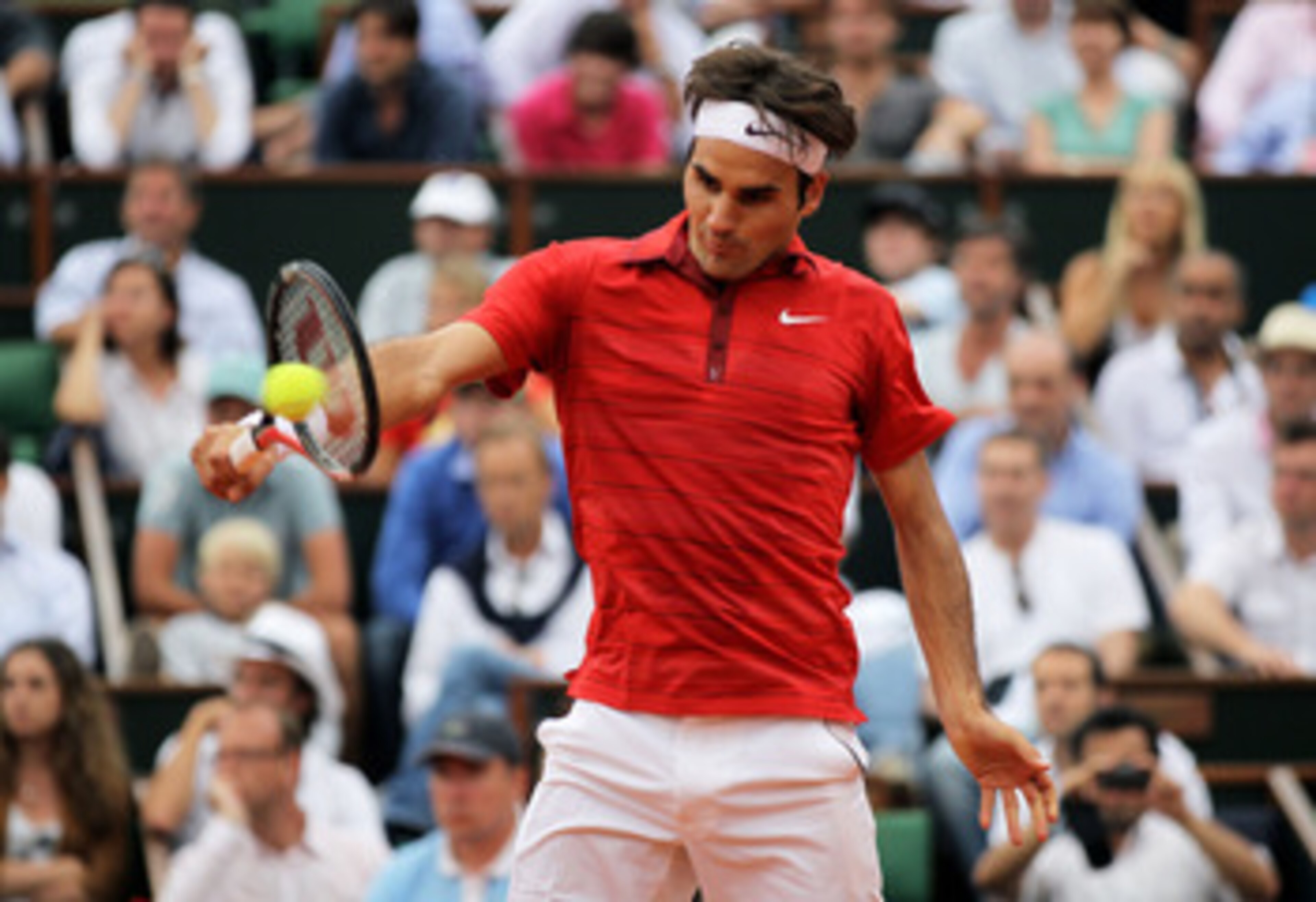 PARIS, FRANCE - JUNE 03: Roger Federer of Switzerland hits a backhand during the men's singles semi final match between Roger Federer of Switzerland and Novak Djokovic of Serbia on day thirteen of the French Open at Roland Garros on June 3, 2011 in Paris PARIS, FRANCE - JUNE 03: Roger Federer of Switzerland hits a backhand during the men's singles semi final match between Roger Federer of Switzerland and Novak Djokovic of Serbia on day thirteen of the French Open at Roland Garros on June 3, 2011 in Paris