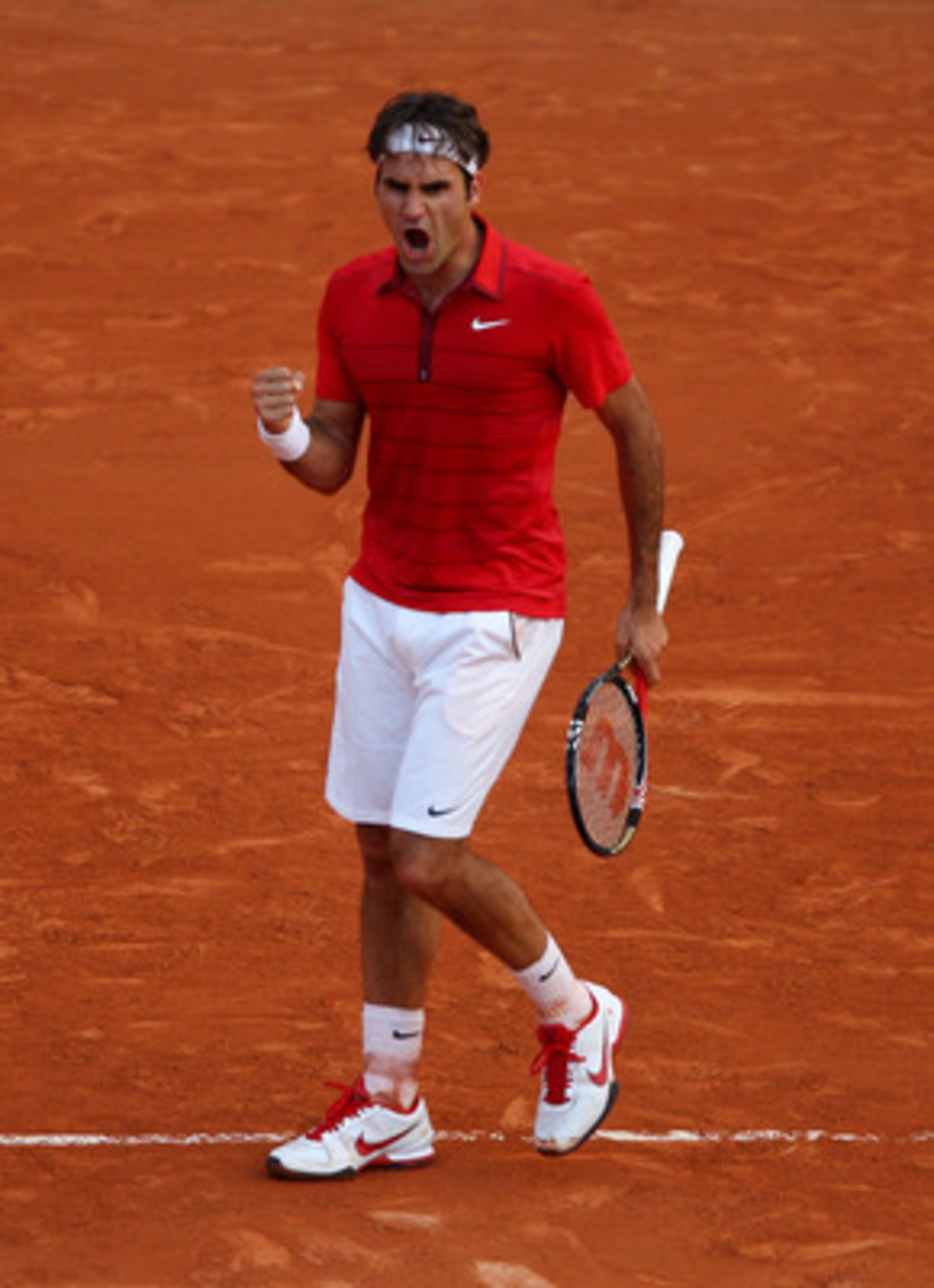 PARIS, FRANCE - JUNE 03: Roger Federer of Switzerland celebrates a point during the men's singles semi final match between Roger Federer of Switzerland and Novak Djokovic of Serbia on day thirteen of the French Open at Roland Garros on June 3, 2011 in Pa PARIS, FRANCE - JUNE 03: Roger Federer of Switzerland celebrates a point during the men's singles semi final match between Roger Federer of Switzerland and Novak Djokovic of Serbia on day thirteen of the French Open at Roland Garros on June 3, 2011 in Pa