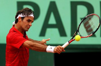 PARIS, FRANCE - JUNE 03:  Roger Federer of Switzerland hits a backhand during the men's singles semi final match between Roger Federer of Switzerland and Novak Djokovic of Serbia on day thirteen of the French Open at Roland Garros on June 3, 2011 in Paris