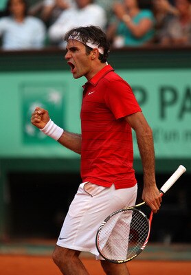 PARIS, FRANCE - JUNE 03:  Roger Federer of Switzerland celebrates a point during the men's singles semi final match between Roger Federer of Switzerland and Novak Djokovic of Serbia on day thirteen of the French Open at Roland Garros on June 3, 2011 in Pa