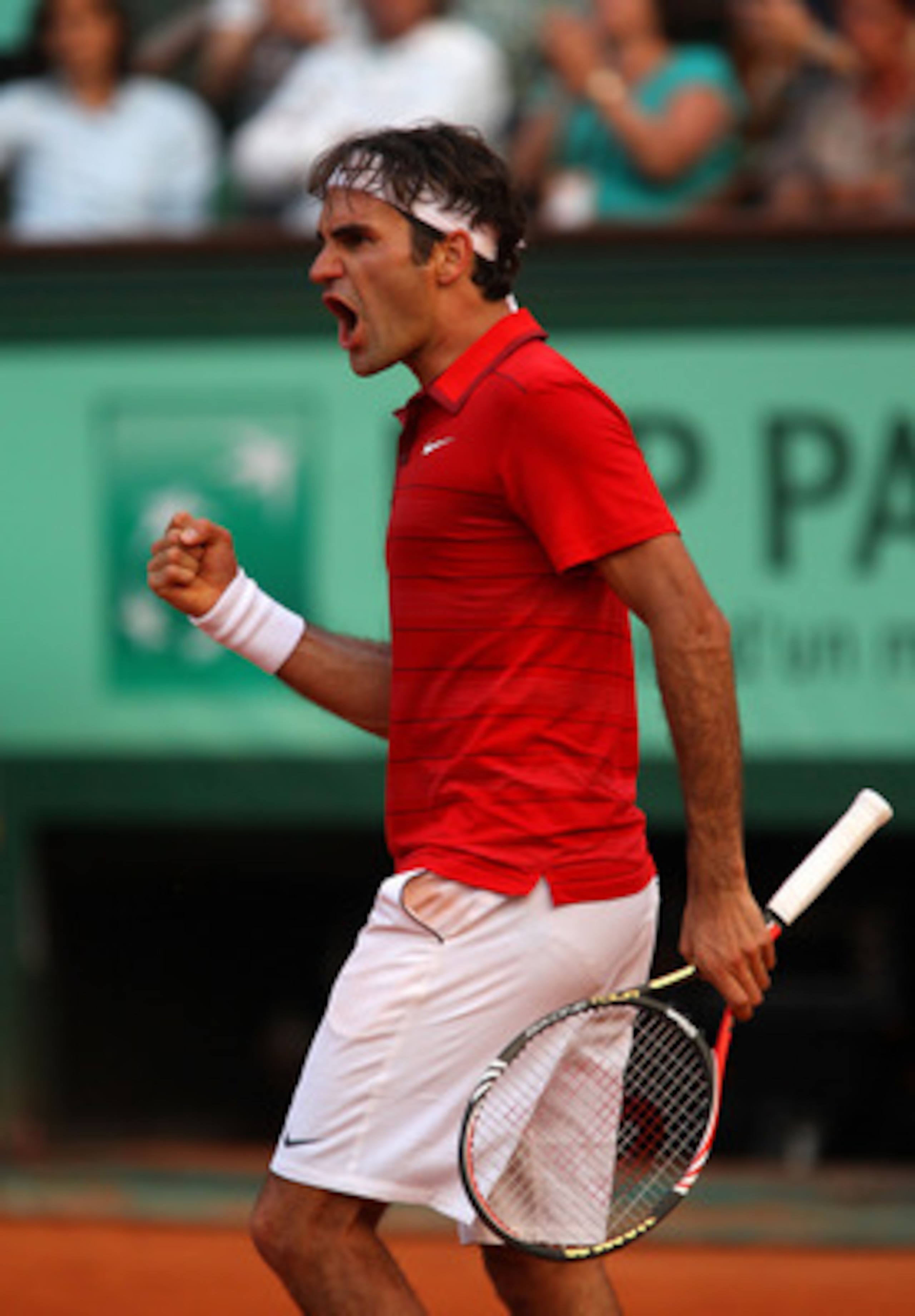 PARIS, FRANCE - JUNE 03:  Roger Federer of Switzerland celebrates a point during the men's singles semi final match between Roger Federer of Switzerland and Novak Djokovic of Serbia on day thirteen of the French Open at Roland Garros on June 3, 2011 in Pa