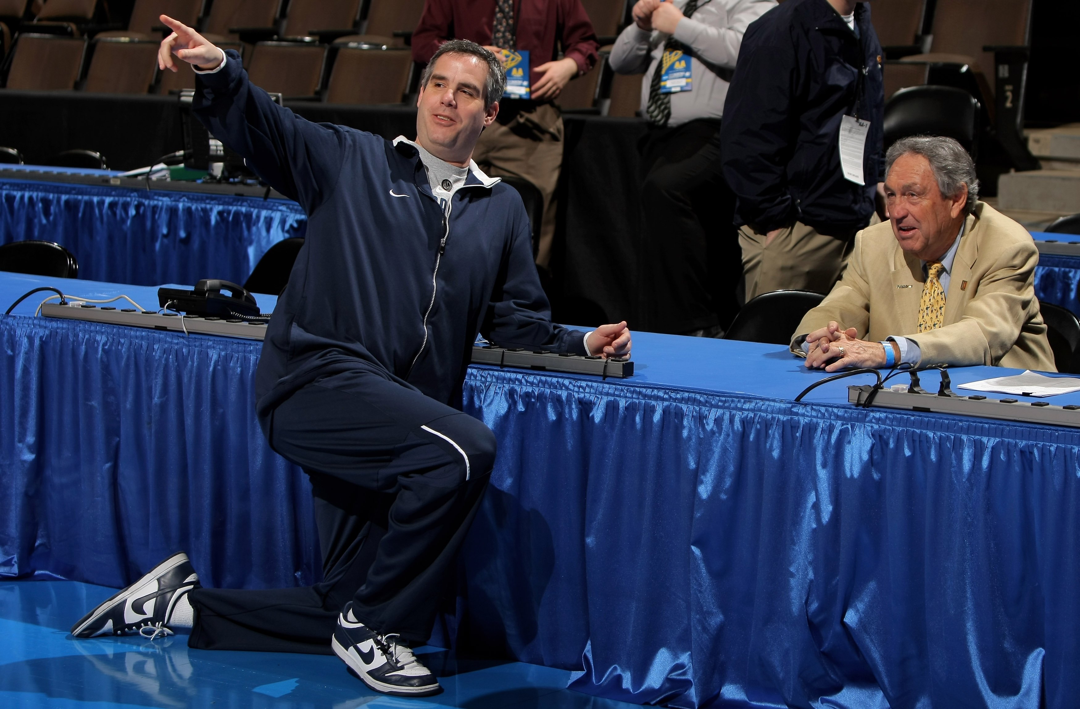 DENVER - MARCH 19:  Head coach Scott Sutton (L) of the Oral Roberts University chats with his father Eddie Sutton as he sits courtside during his son's practice session on the eve of the first round of the Men's NCAA Basketball East Region at the Pepsi Ce
