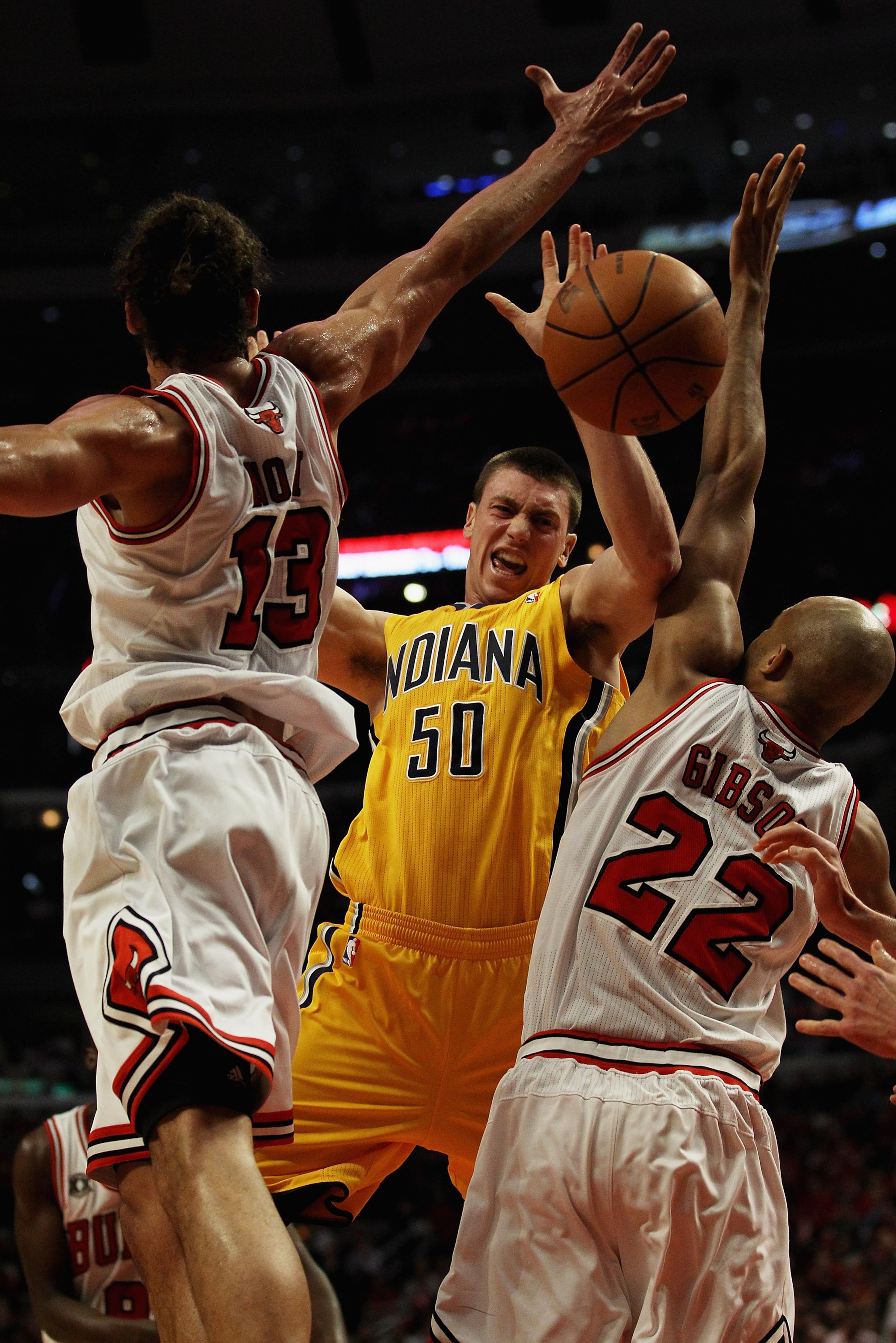 CHICAGO, IL - APRIL 26: Tyler Hansbrough #50 of the Indiana Pacers looses control of the ball under pressure from Joakim Noah #13 and Taj Gibson #22 of the Chicago Bulls in Game Five of the Eastern Conference Quarterfinals in the 2011 NBA Playoffs at the