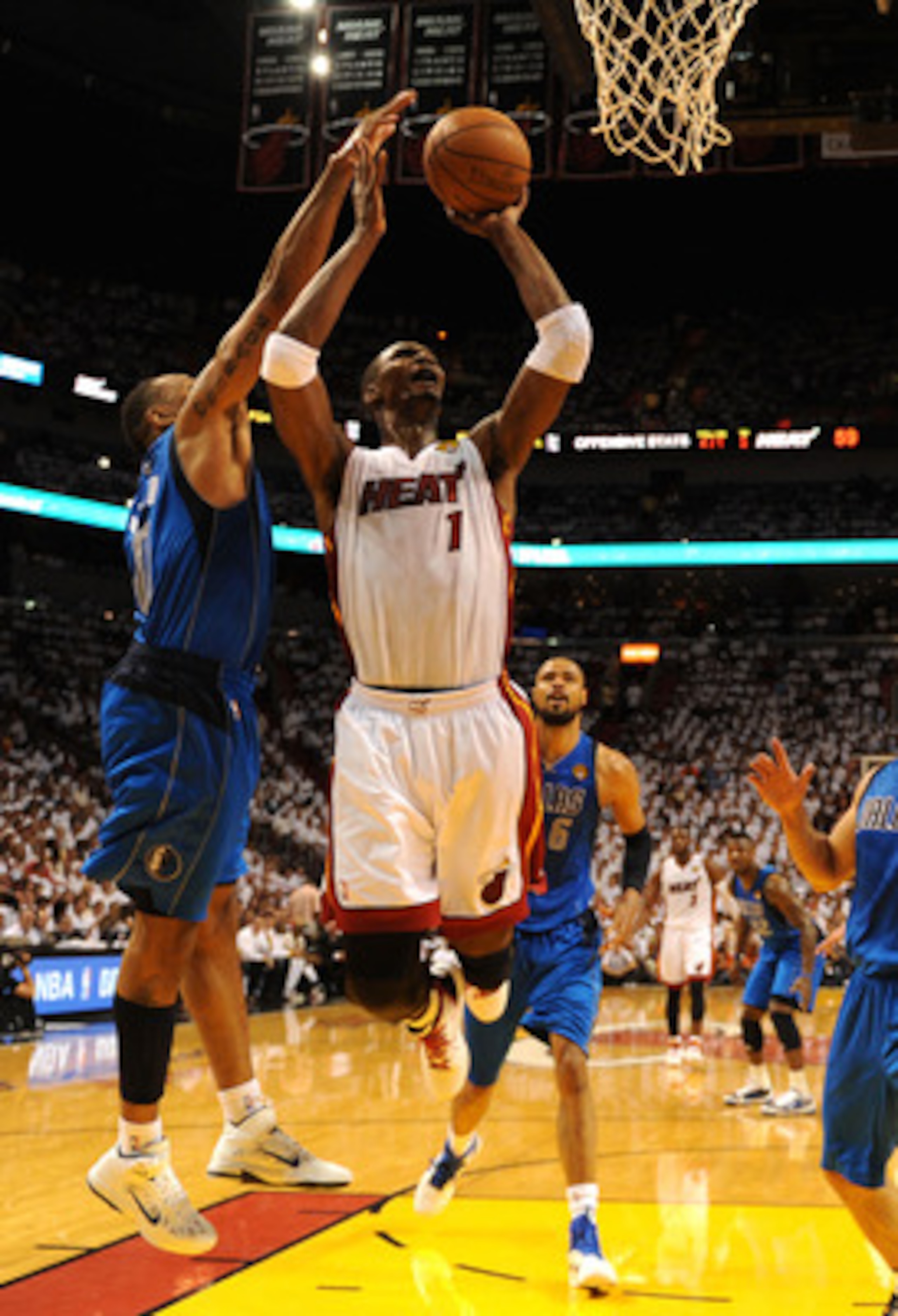 MIAMI, FL - JUNE 02:  Chris Bosh #1 of the Miami Heat attempts a shot against Shawn Marion #0 of the Dallas Mavericks in Game Two of the 2011 NBA Finals at American Airlines Arena on June 2, 2011 in Miami, Florida. The Mavericks won 95-93. NOTE TO USER: U