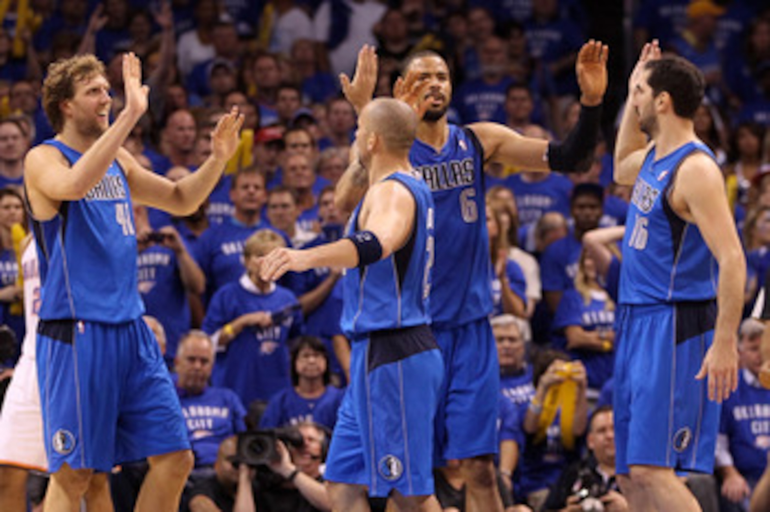 OKLAHOMA CITY, OK - MAY 23:  (L-R) Dirk Nowitzki #41, Jason Kidd #2, Tyson Chandler #6 and Peja Stojakovic #16 of the Dallas Mavericks react in the fourth quarter while taking on the Oklahoma City Thunder in Game Four of the Western Conference Finals duri
