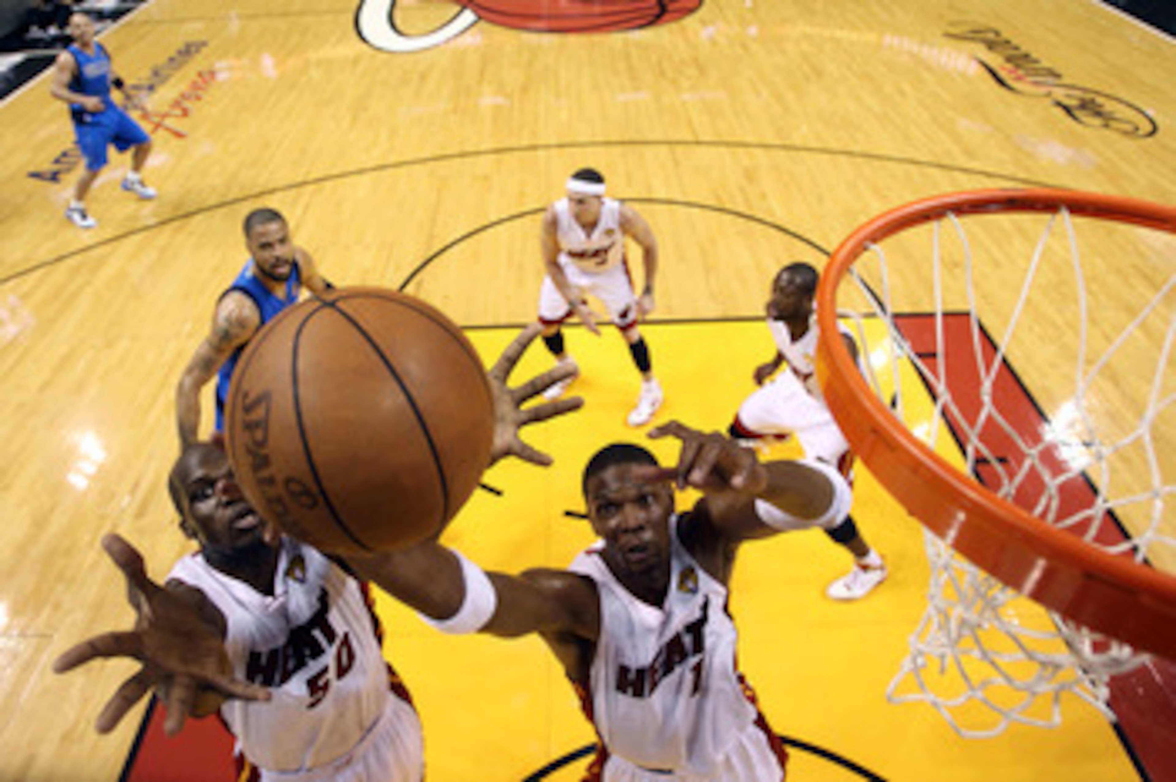 MIAMI, FL - MAY 31:  Joel Anthony #50 and Chris Bosh #1 of the Miami Heat go up for a rebound in the first quarter while taking on the Dallas Mavericks in Game One of the 2011 NBA Finals at American Airlines Arena on May 31, 2011 in Miami, Florida. NOTE T