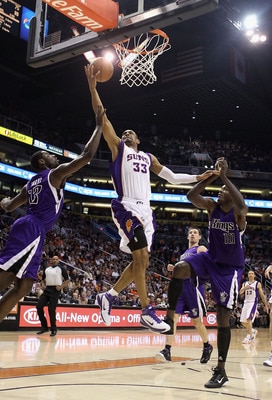 PHOENIX, AZ - FEBRUARY 13:  Grant Hill #13 of the Phoenix Suns lays up a shot past Tyreke Evans #13 and Samuel Dalembert #10 of the Sacramento Kings during the NBA game at US Airways Center on February 13, 2011 in Phoenix, Arizona.  NOTE TO USER: User exp