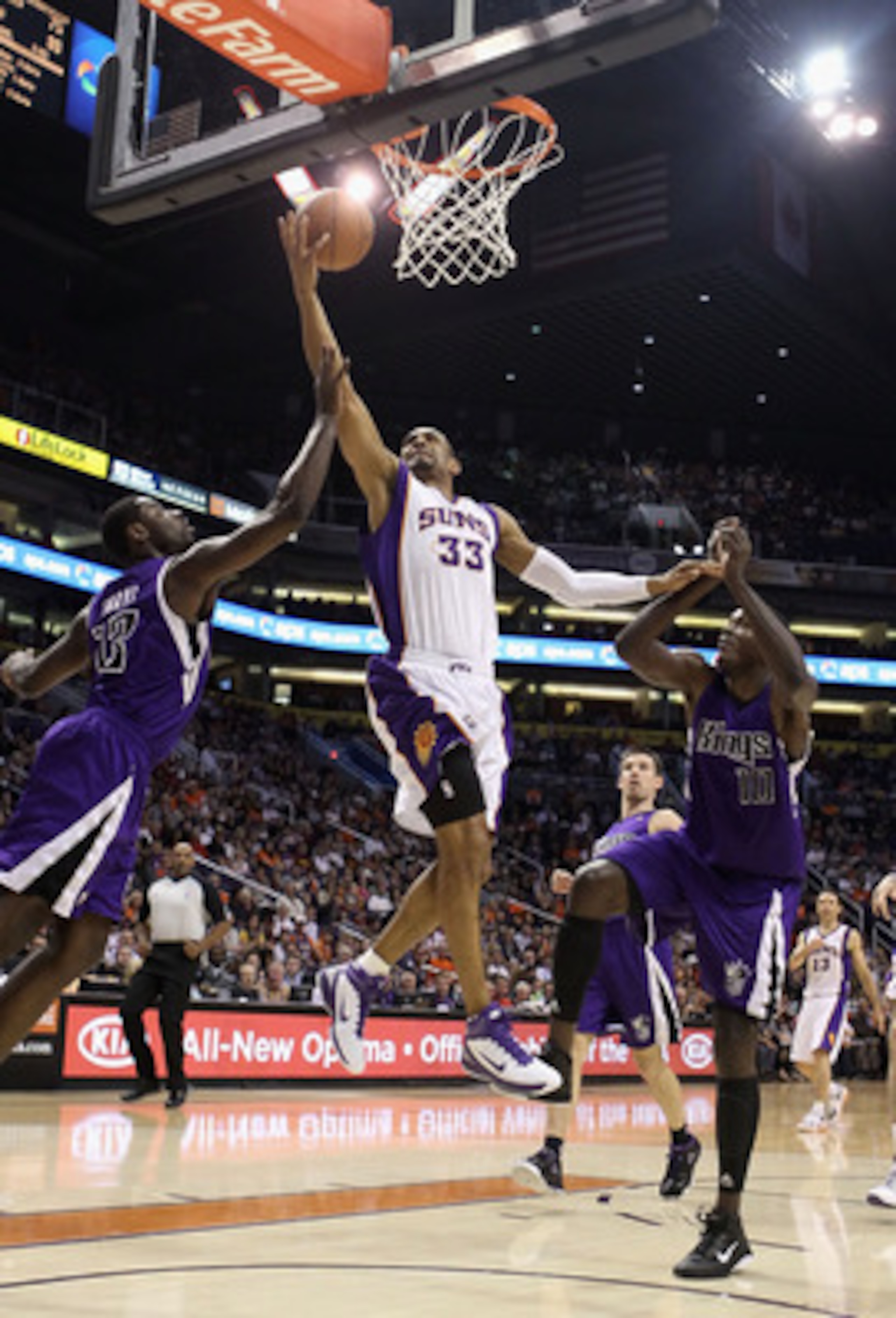 PHOENIX, AZ - FEBRUARY 13: Grant Hill #13 of the Phoenix Suns lays up a shot past Tyreke Evans #13 and Samuel Dalembert #10 of the Sacramento Kings during the NBA game at US Airways Center on February 13, 2011 in Phoenix, Arizona. NOTE TO USER: User exp PHOENIX, AZ - FEBRUARY 13: Grant Hill #13 of the Phoenix Suns lays up a shot past Tyreke Evans #13 and Samuel Dalembert #10 of the Sacramento Kings during the NBA game at US Airways Center on February 13, 2011 in Phoenix, Arizona. NOTE TO USER: User exp