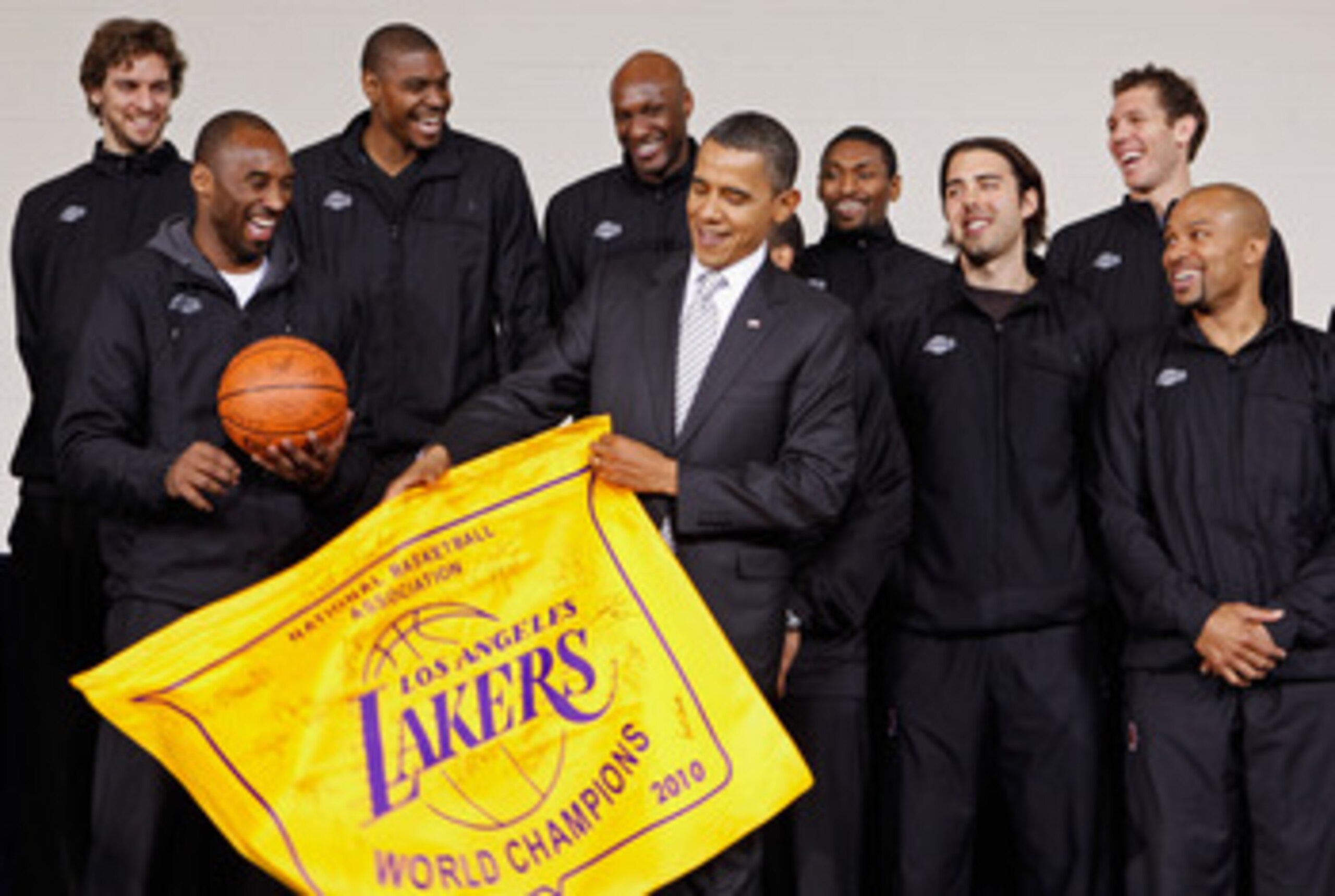 WASHINGTON, DC - DECEMBER 13:  (AFP OUT) U.S. President Barack Obama (C) receives an autographed championship flag and basketball from members of the Los Angeles Lakers (L-R) Paul Gasol, Kobe Bryant, Andrew Bynum, Lamar Odom, Ron Artest, Aleksandar Vujaci