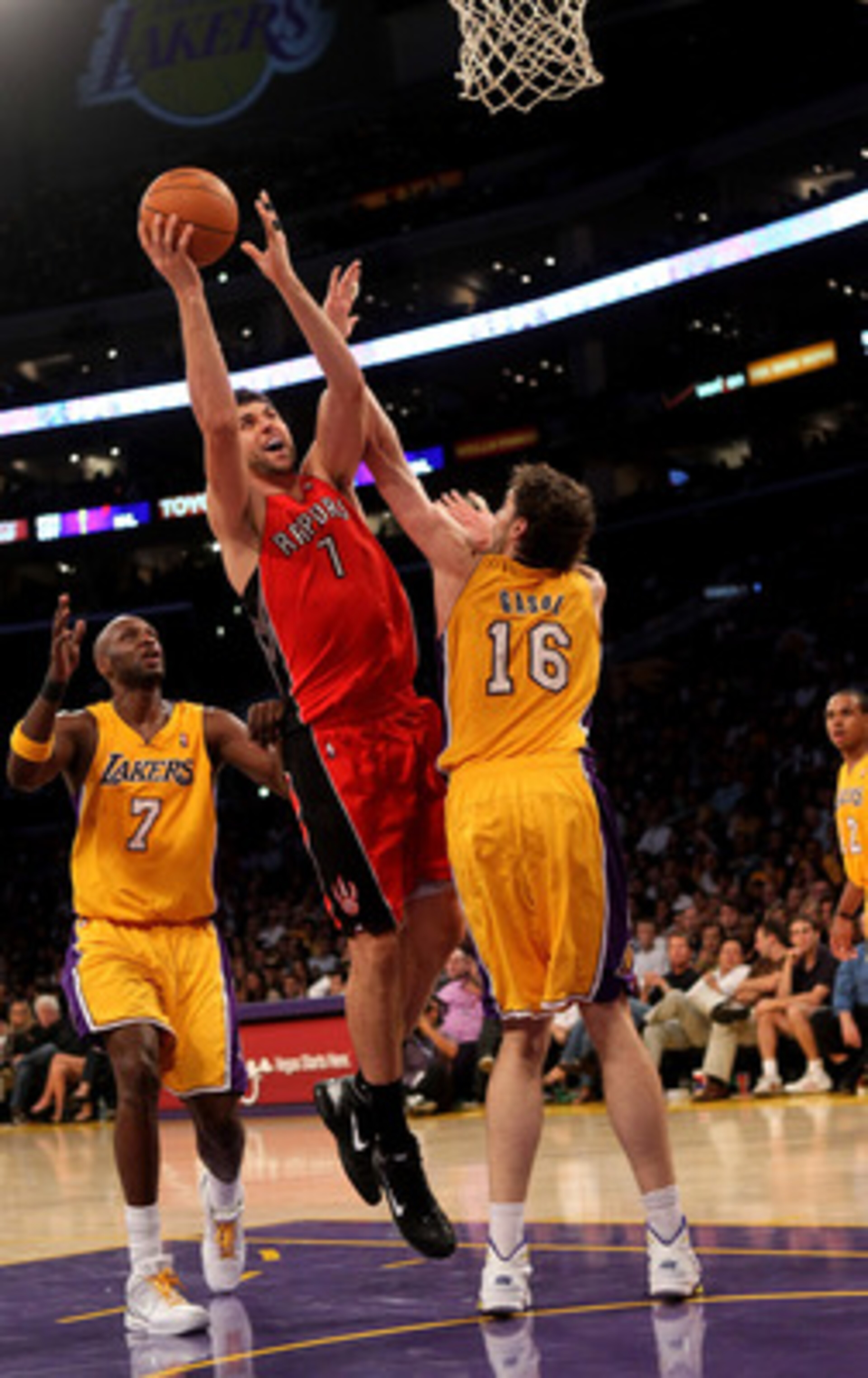 LOS ANGELES - NOVEMBER 5: Andrea Bargnani #7 of the Toronto Raptors shoots over Pau Gasol #16 and Lamar Odom #7 of the Los Angeles Lakers at Staples Center on November 5, 2010 in Los Angeles, California. The Lakers won 108-102. NOTE TO USER: User expr LOS ANGELES - NOVEMBER 5: Andrea Bargnani #7 of the Toronto Raptors shoots over Pau Gasol #16 and Lamar Odom #7 of the Los Angeles Lakers at Staples Center on November 5, 2010 in Los Angeles, California. The Lakers won 108-102. NOTE TO USER: User expr