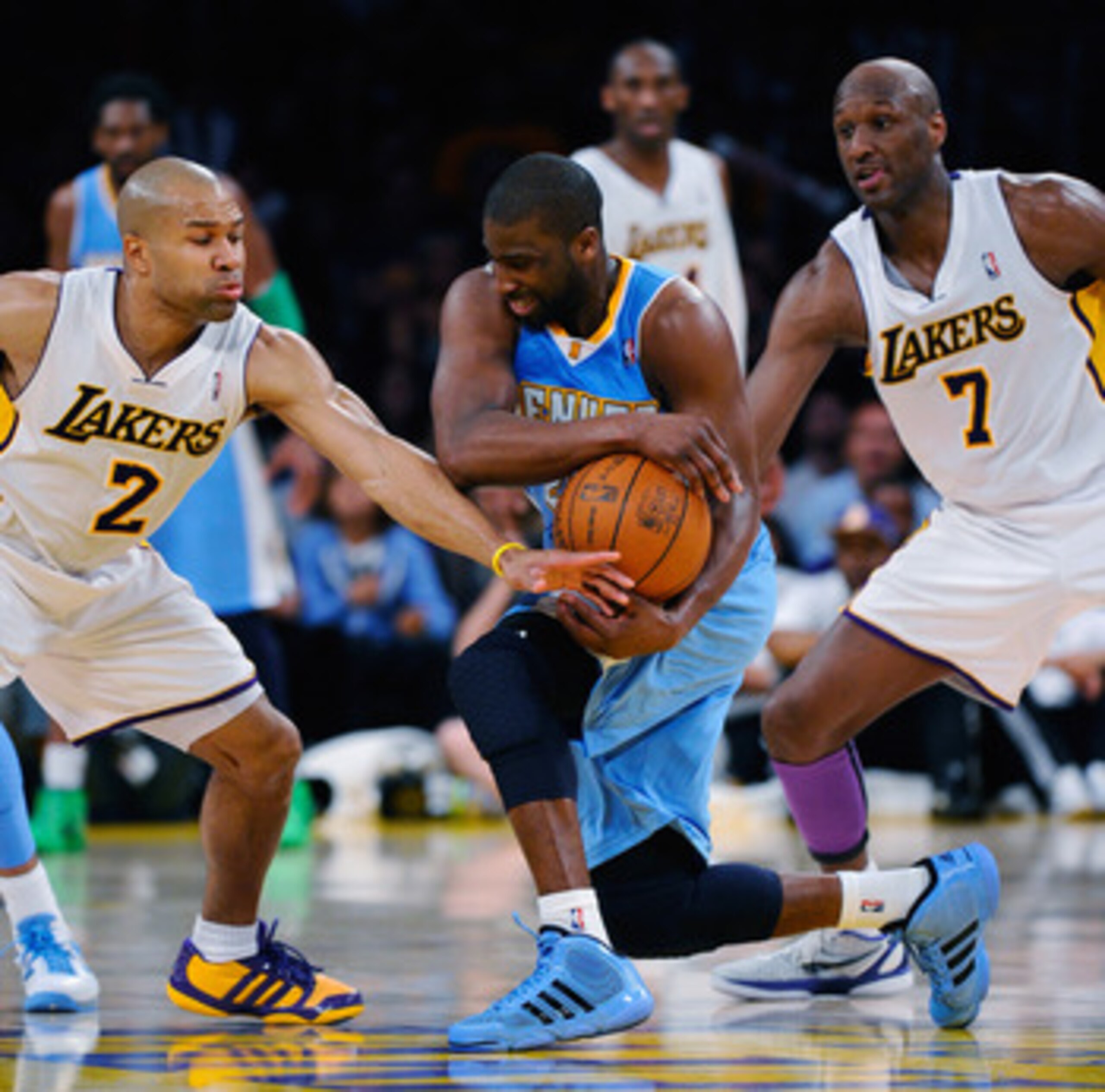 LOS ANGELES, CA - APRIL 03:  Raymond Felton #20 of the Denver Nuggets is pressured by Derek Fisher #5 and Lamar Odom #7 of the Los Angeles Lakers during the NBA basketball game at Staples Center on April 3, 2011 in Los Angeles, California. NOTE TO USER: U