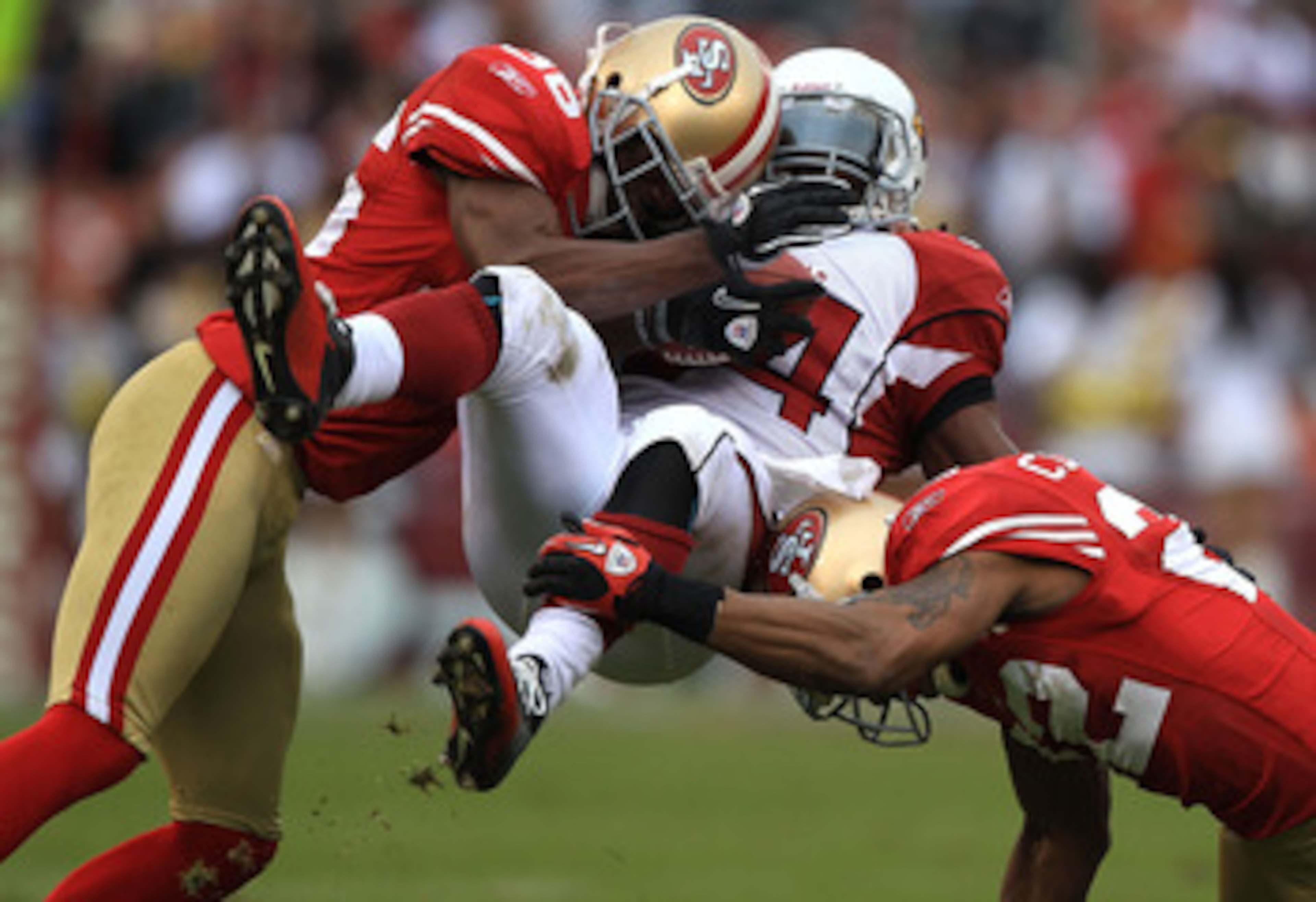 SAN FRANCISCO, CA - JANUARY 2:  Tim Hightower #34 of the Arizona Cardinals is tackled by Nate Clements #22 and Shawntae Spencer #36 of the San Francisco 49ers  during an NFL game at Candlestick Park on January 2, 2011 in San Francisco, California.(Photo b