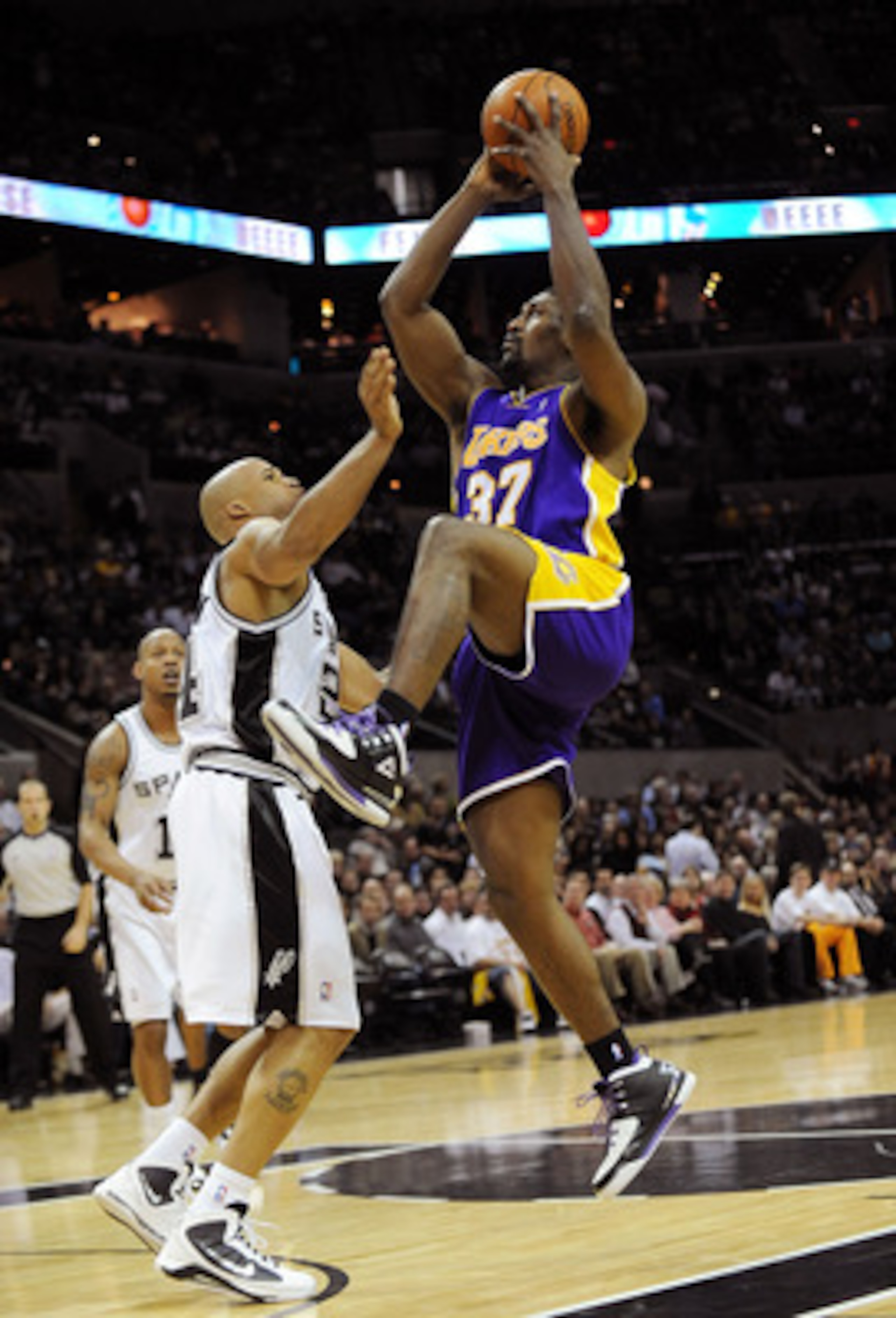 SAN ANTONIO - JANUARY 12:  Forward Ron Artest #37 of the Los Angeles Lakers takes a shot against Richard Jefferson #24 of the San Antonio Spurs on January 12, 2010 at AT&T Center in San Antonio, Texas.  NOTE TO USER: User expressly acknowledges and agrees
