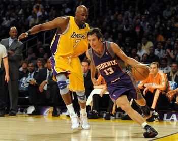 LOS ANGELES, CA - DECEMBER 10:  Steve Nash #13 of the Phoenix Suns dribbles around Lamar Odom #7 of the Los Angeles Lakers during the first half at the Staples Center on December, 10 2008 in Los Angeles, California.   NOTE TO USER: User expressly acknowle
