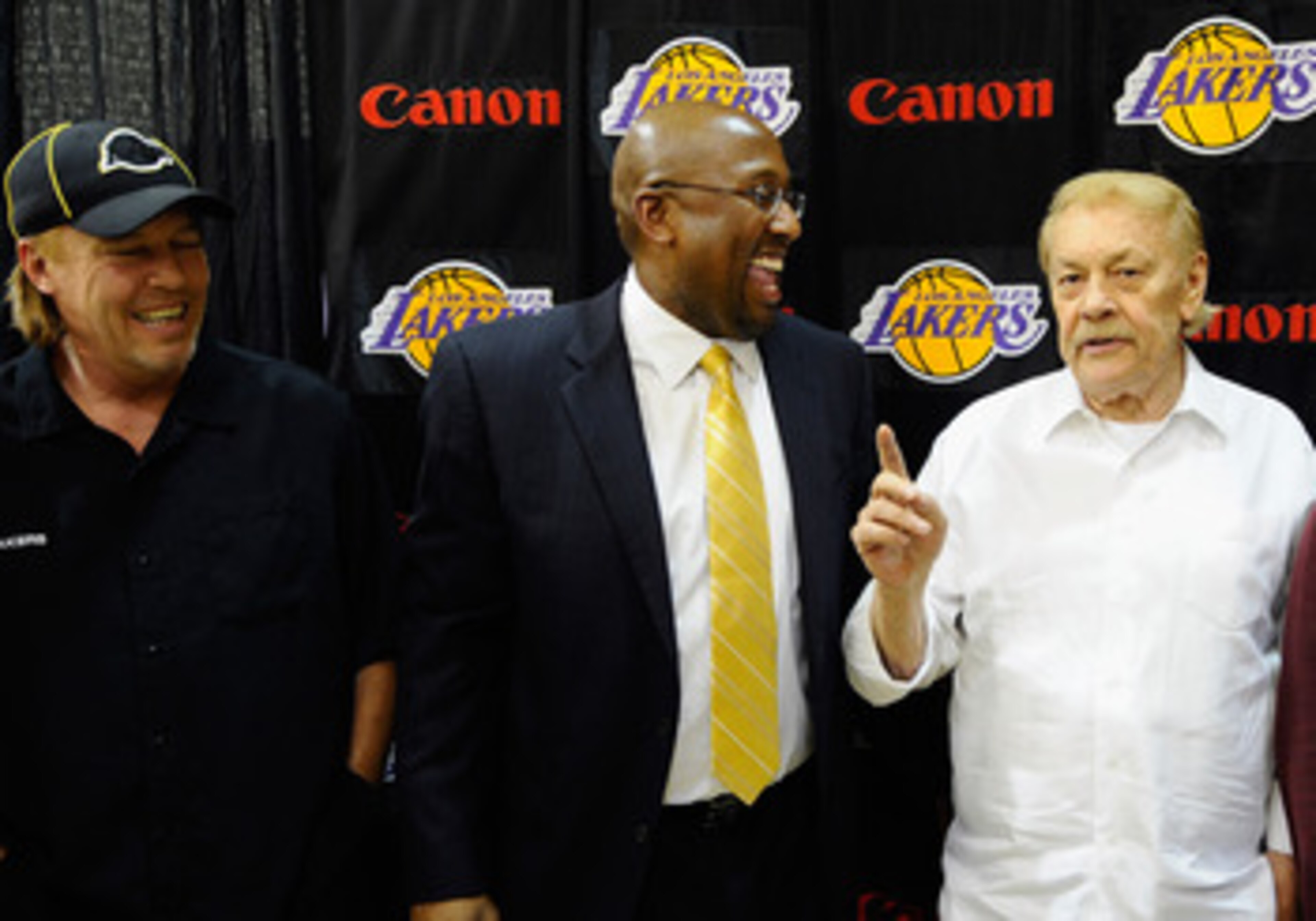 EL SEGUNDO, CA - MAY 31: Mike Brown, (C) the new head coach for the Los Angeles Lakers, looks at team owner Jerry Buss (R) speaks while Jim Buss, vice president of player personnel, looks on after Brown's introductory news conference at the team's traini EL SEGUNDO, CA - MAY 31: Mike Brown, (C) the new head coach for the Los Angeles Lakers, looks at team owner Jerry Buss (R) speaks while Jim Buss, vice president of player personnel, looks on after Brown's introductory news conference at the team's traini