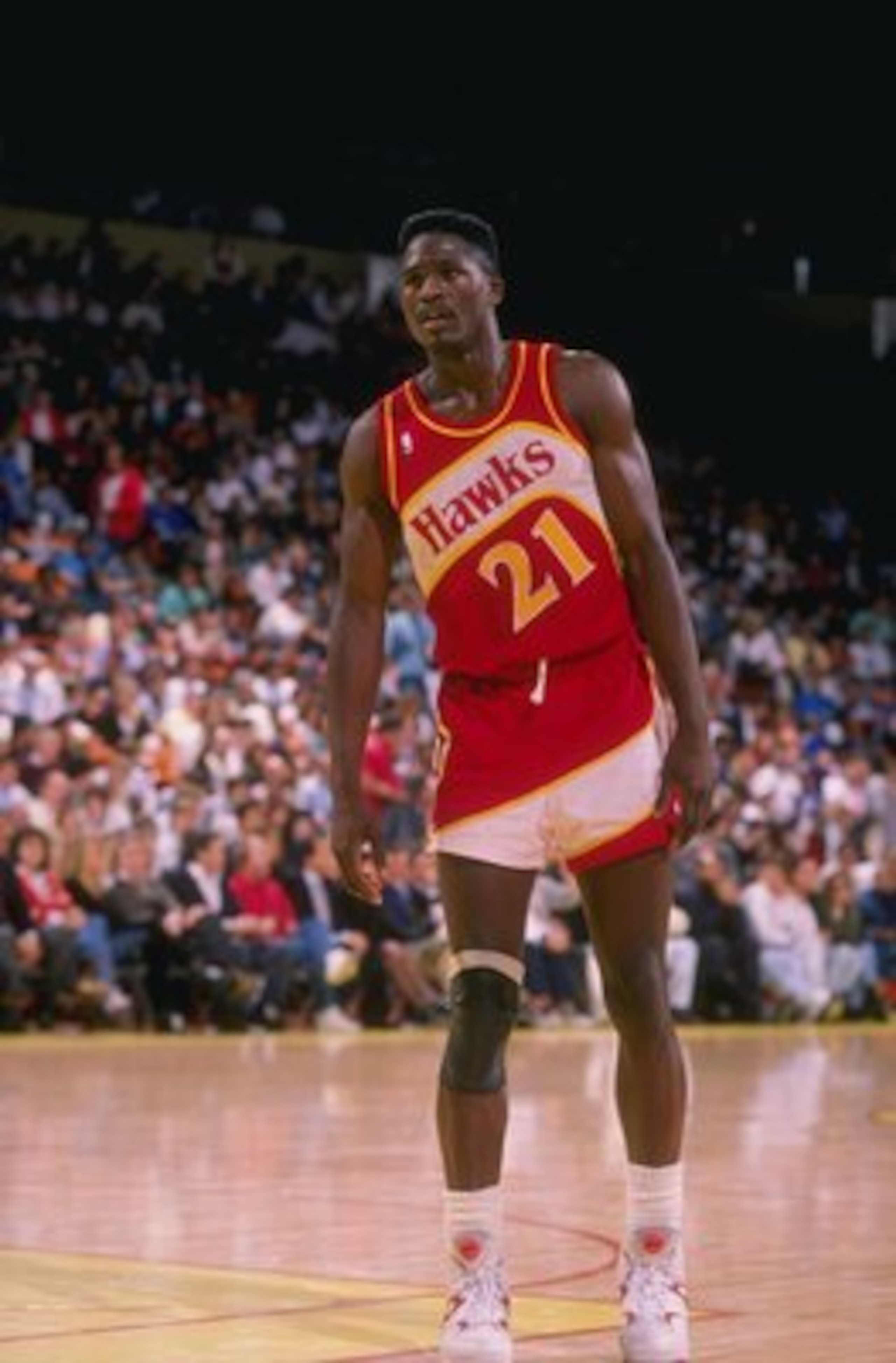 Forward Dominique Wilkins of the Atlanta Hawks stands on the court during a game.