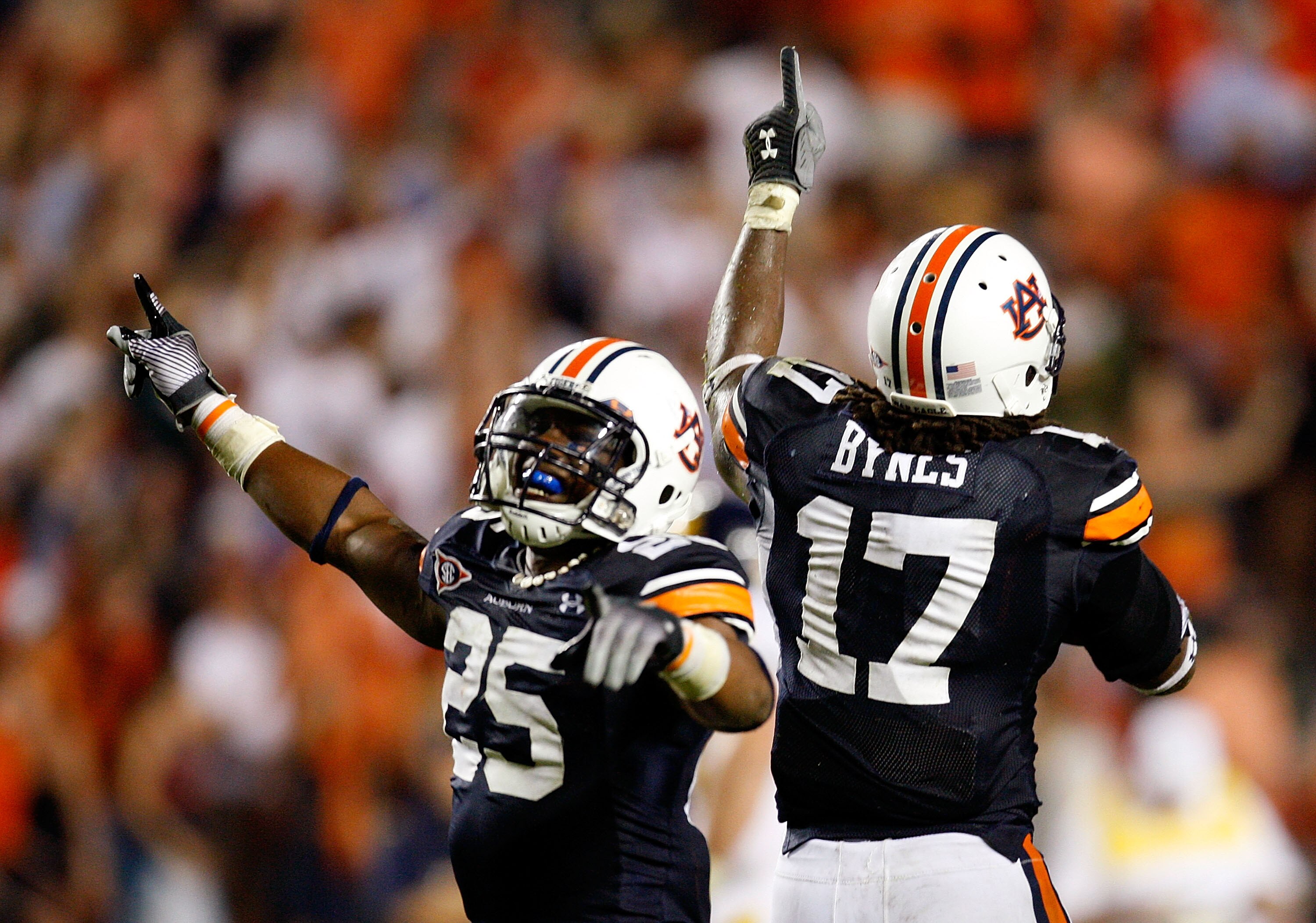 AUBURN, AL - SEPTEMBER 19:  Daren Bates #25 and Josh Bynes #17 of the Auburn Tigers celebrate Bynes interception in the final minutes of their 41-30 win over the West Virginia Mountaineers at Jordan-Hare Stadium on September 19, 2009 in Auburn, Alabama.