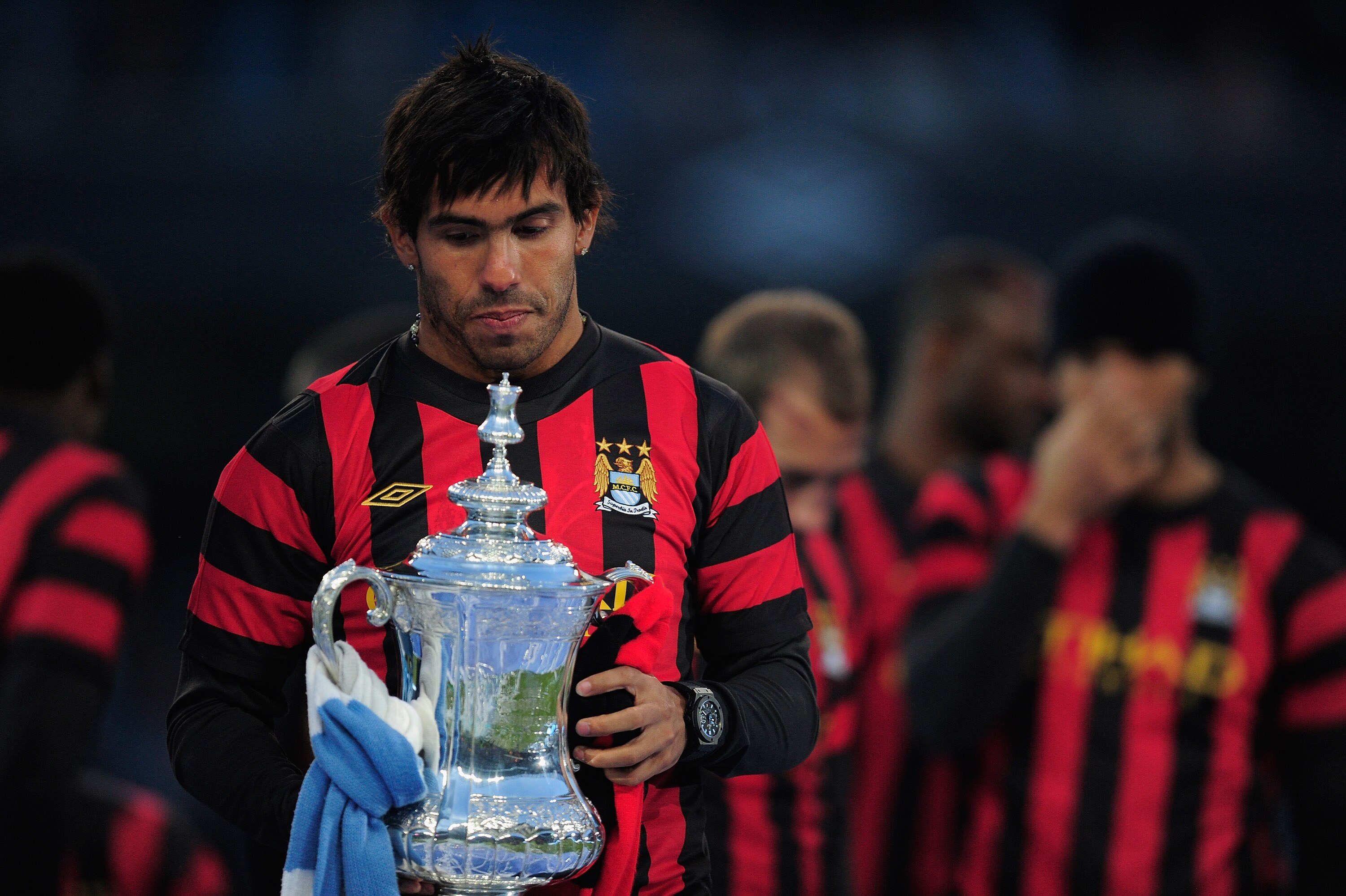 MANCHESTER, ENGLAND - MAY 23: Carlos Tevez of Manchester City lifts the FA Cup tduring the Manchester City FA Cup Winners Parade at the City of Manchester stadium on May 23, 2011 in Manchester, United Kingdom. (Photo by Jamie McDonald/Getty Images) MANCHESTER, ENGLAND - MAY 23: Carlos Tevez of Manchester City lifts the FA Cup tduring the Manchester City FA Cup Winners Parade at the City of Manchester stadium on May 23, 2011 in Manchester, United Kingdom. (Photo by Jamie McDonald/Getty Images)