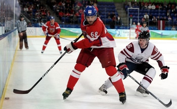 VANCOUVER, BC - FEBRUARY 23:  Jaromir Jagr #68 of Czech Republic is pursued by Kaspars Daugavins #16 of Latvia during the ice hockey Men's Play-off qualification match between the Czech Republic and Latvia on day 12 of the Vancouver 2010 Winter Olympics a