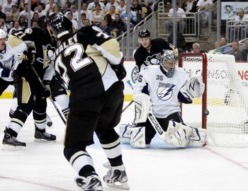 PITTSBURGH, PA - APRIL 13: Dwayne Roloson #35 of the Tampa Bay Lightning makes a glove save on Alexei Kovalev #72 of the Pittsburgh Penguins in Game One of the Eastern Conference Quarterfinals during the 2011 NHL Stanley Cup Playoffs at Consol Energy Cent