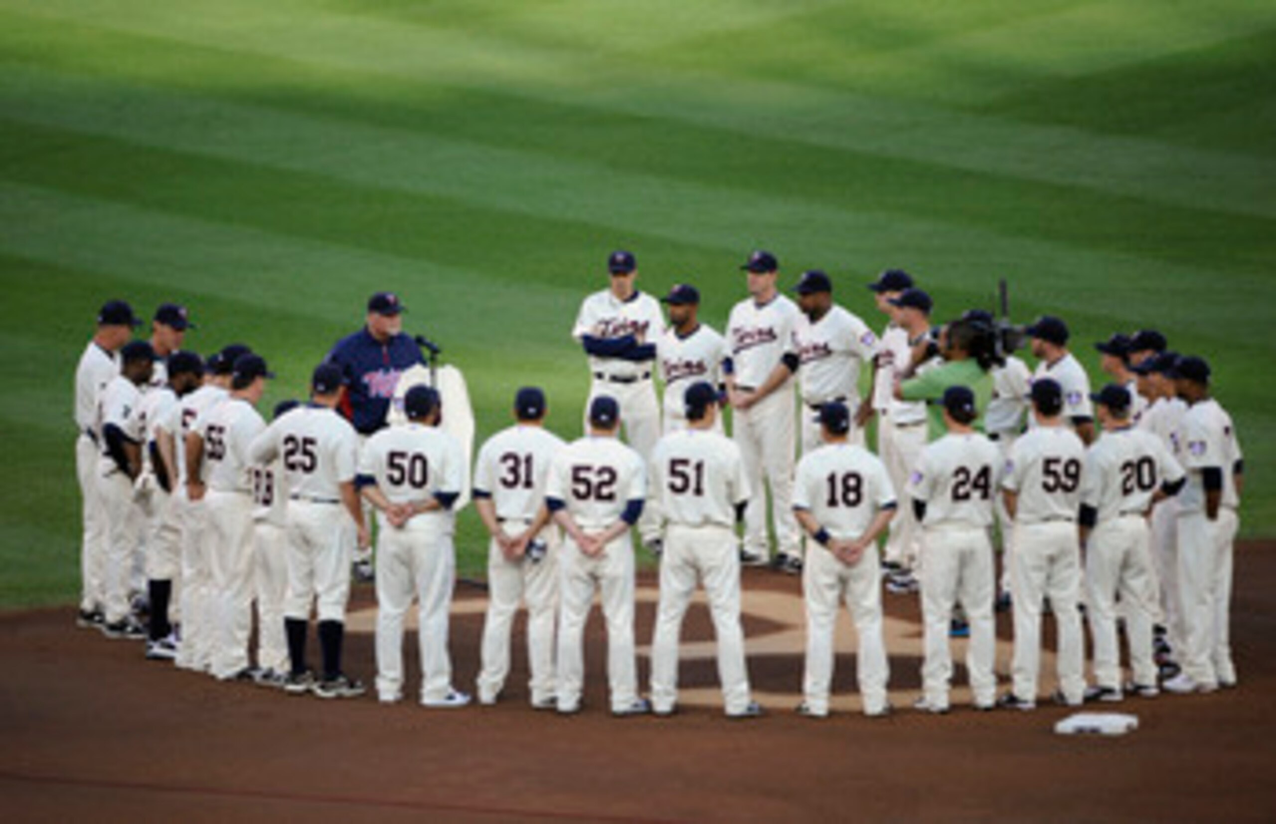 MINNEAPOLIS, MN - MAY 23: Manager Ron Gardenhire #35 of the Minnesota Twins speaks about the late Hall of Famer Harmon Killebrew while the rest of the Minnesota Twins stand around Killebrew's number in the infield dirt behind second base prior to a game a