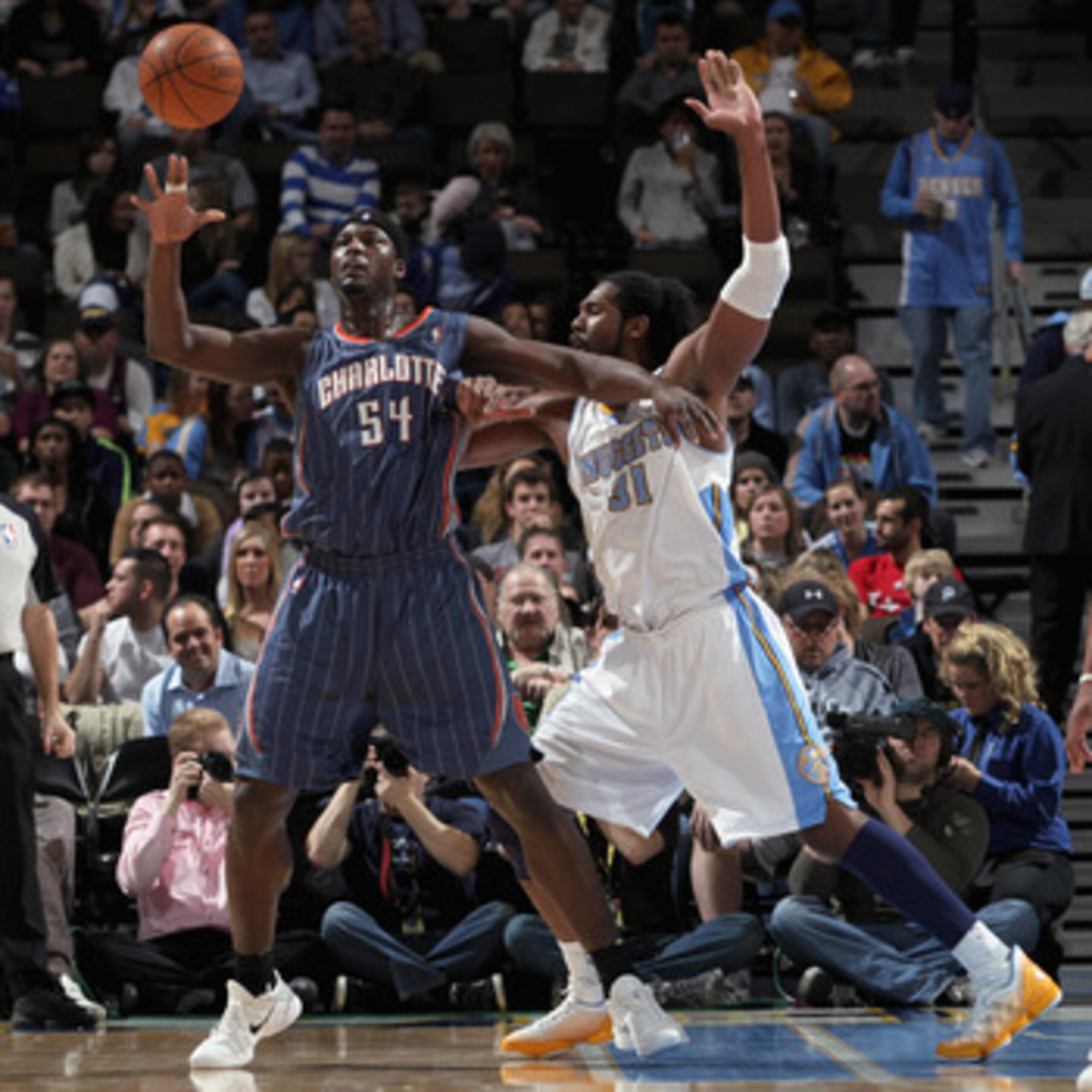 DENVER, CO - MARCH 02:  Kwame Brown #54 of the Charlotte Bobcats collects the ball against the defense of Nene #31 of the Denver Nuggets at the Pepsi Center on March 2, 2011 in Denver, Colorado. NOTE TO USER: User expressly acknowledges and agrees that, b