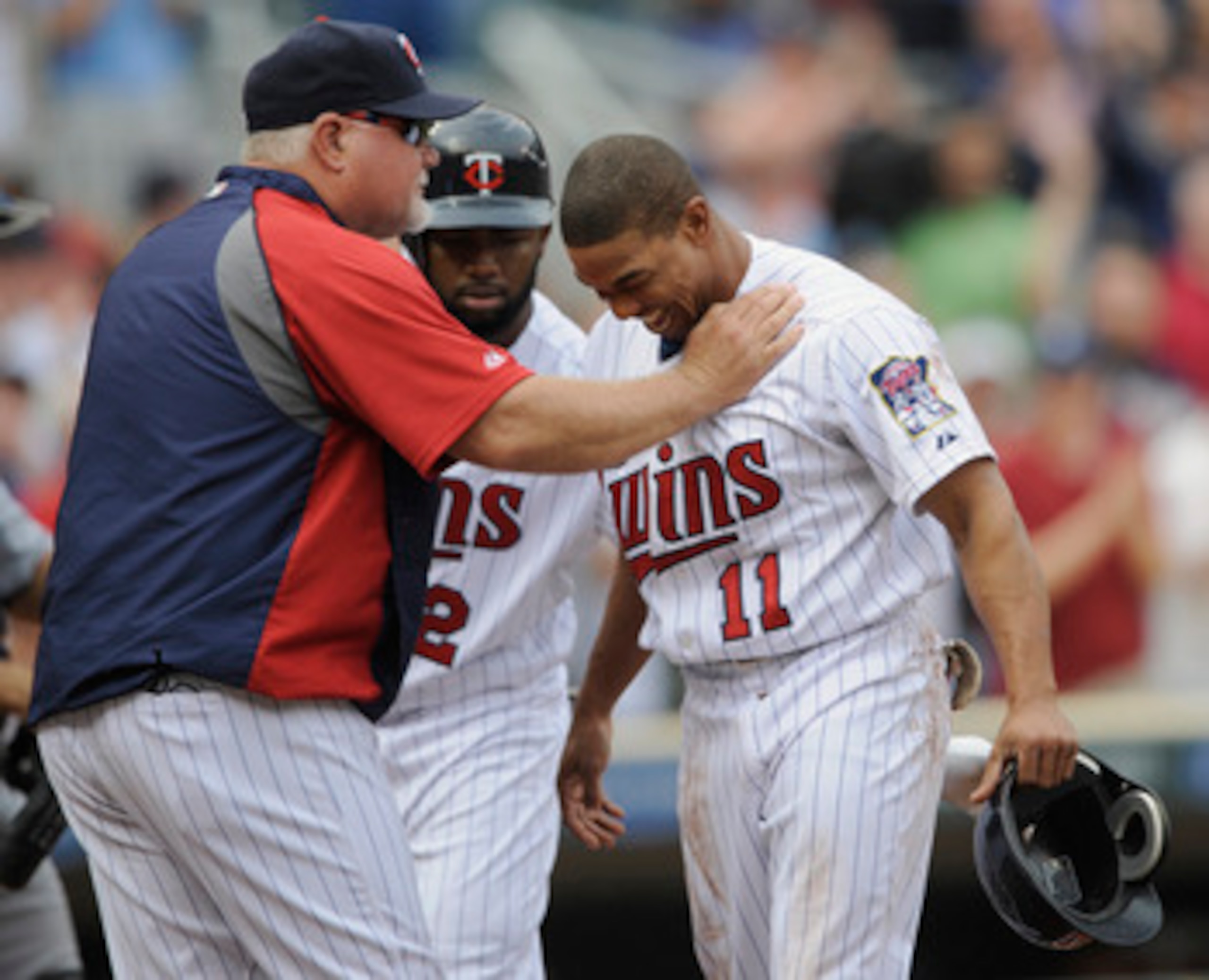 MINNEAPOLIS, MN - MAY 11: Manager Ron Gardenhire #35 of the Minnesota Twins checks on Ben Revere #11 of the Minnesota Twins after a hard slide into home plate by Revere against the Detroit Tigers during in the eighth inning of their game on May 11, 2011 a