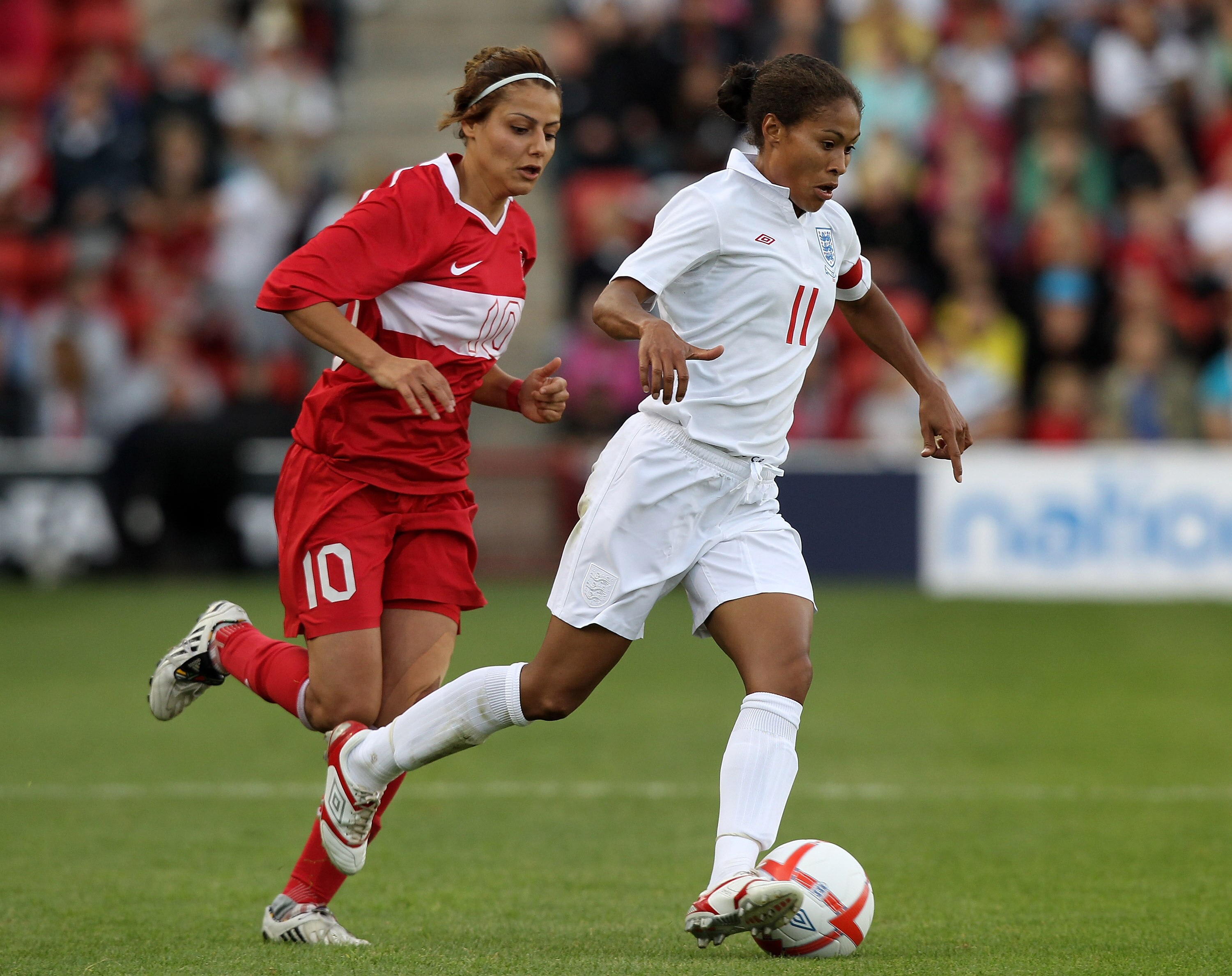 WALSALL, ENGLAND - JULY 29:  Rachel Yankey of England races away from Eylul Elgalp during the FIFA Womens World Cup Qualifiying match between England and Turkey at the Banks's Stadium on July 29, 2010 in Walsall, England.  (Photo by David Rogers/Getty Ima