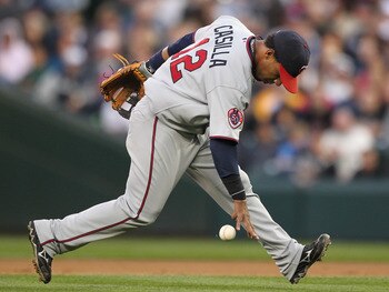 SEATTLE - AUGUST 27:  Shortstop Alexi Casilla #12 of the Minnesota Twins bobbles an infield single by Adam Moore of the Seattle Mariners at Safeco Field on August 27, 2010 in Seattle, Washington. The Twins won 6-3. (Photo by Otto Greule Jr/Getty Images)