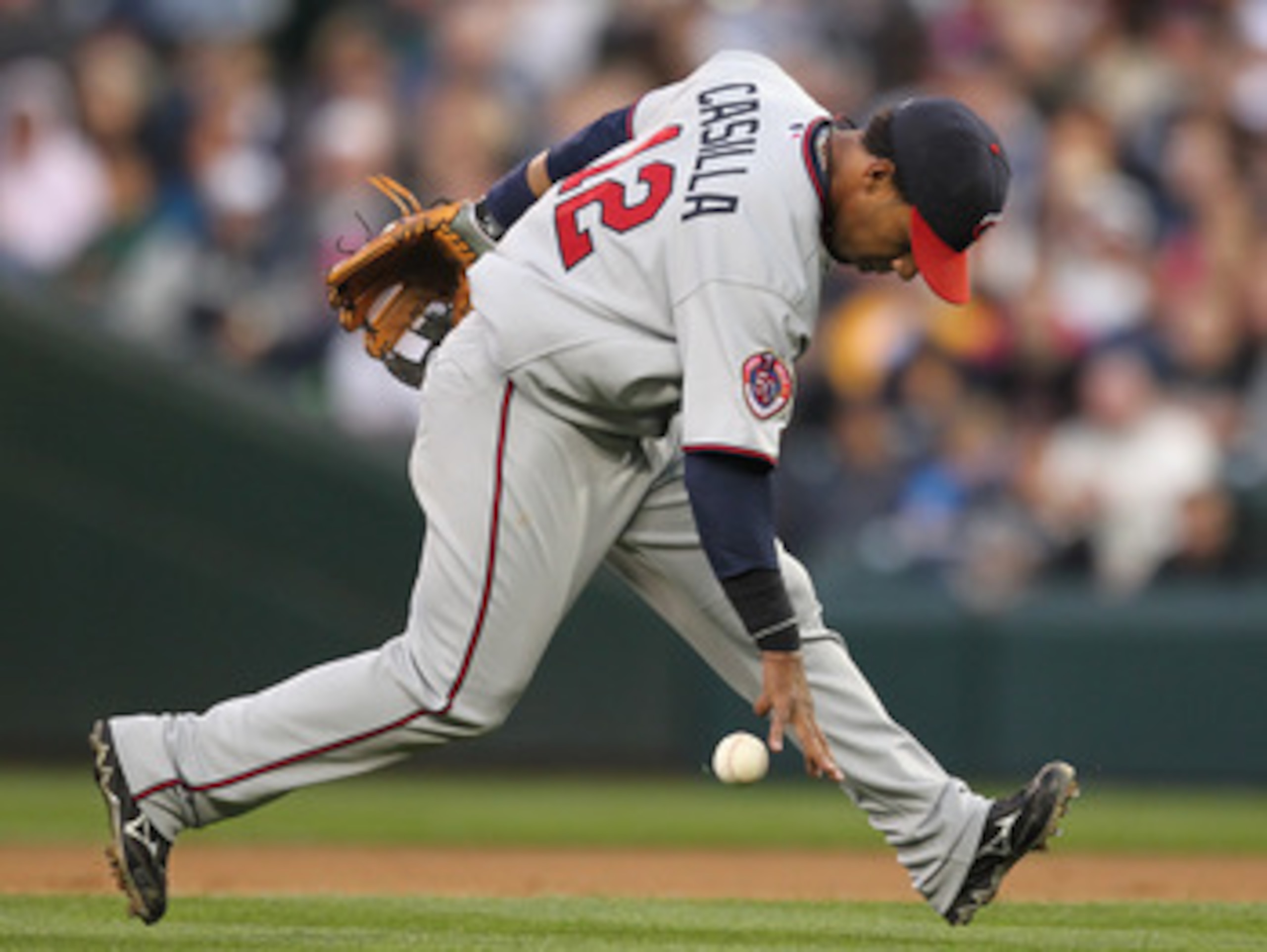 SEATTLE - AUGUST 27:  Shortstop Alexi Casilla #12 of the Minnesota Twins bobbles an infield single by Adam Moore of the Seattle Mariners at Safeco Field on August 27, 2010 in Seattle, Washington. The Twins won 6-3. (Photo by Otto Greule Jr/Getty Images)