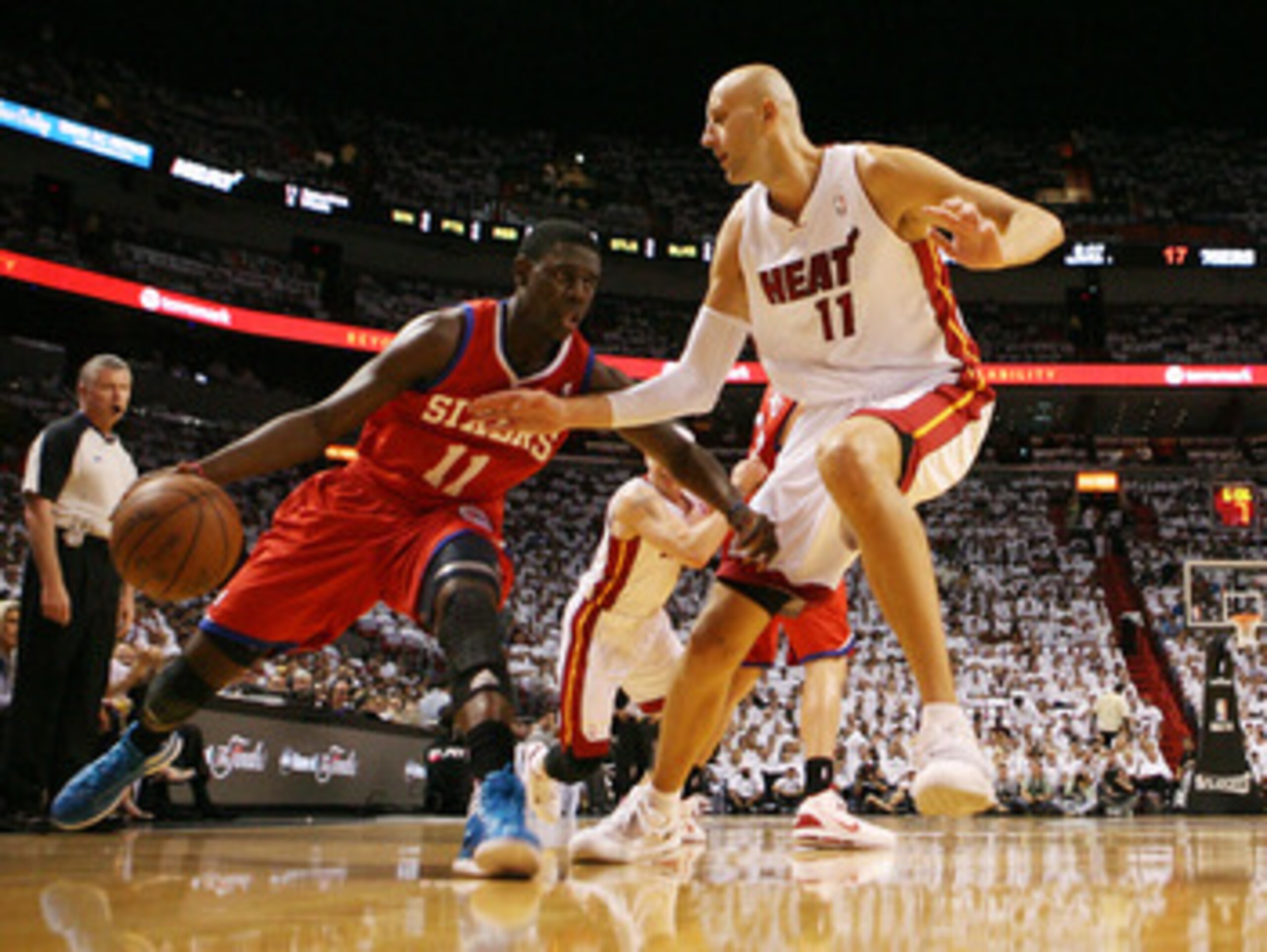 MIAMI, FL - APRIL 16:  Guard Jrue Holiday #11 of the Philadelphia 76ers drives against Center Zydrunas ilgauskas #11 of the Maim Heat at the American Airlines Arena in game one of the Eastern Conference Quarterfinals in the 2011 NBA Playoffs on April 16, 
