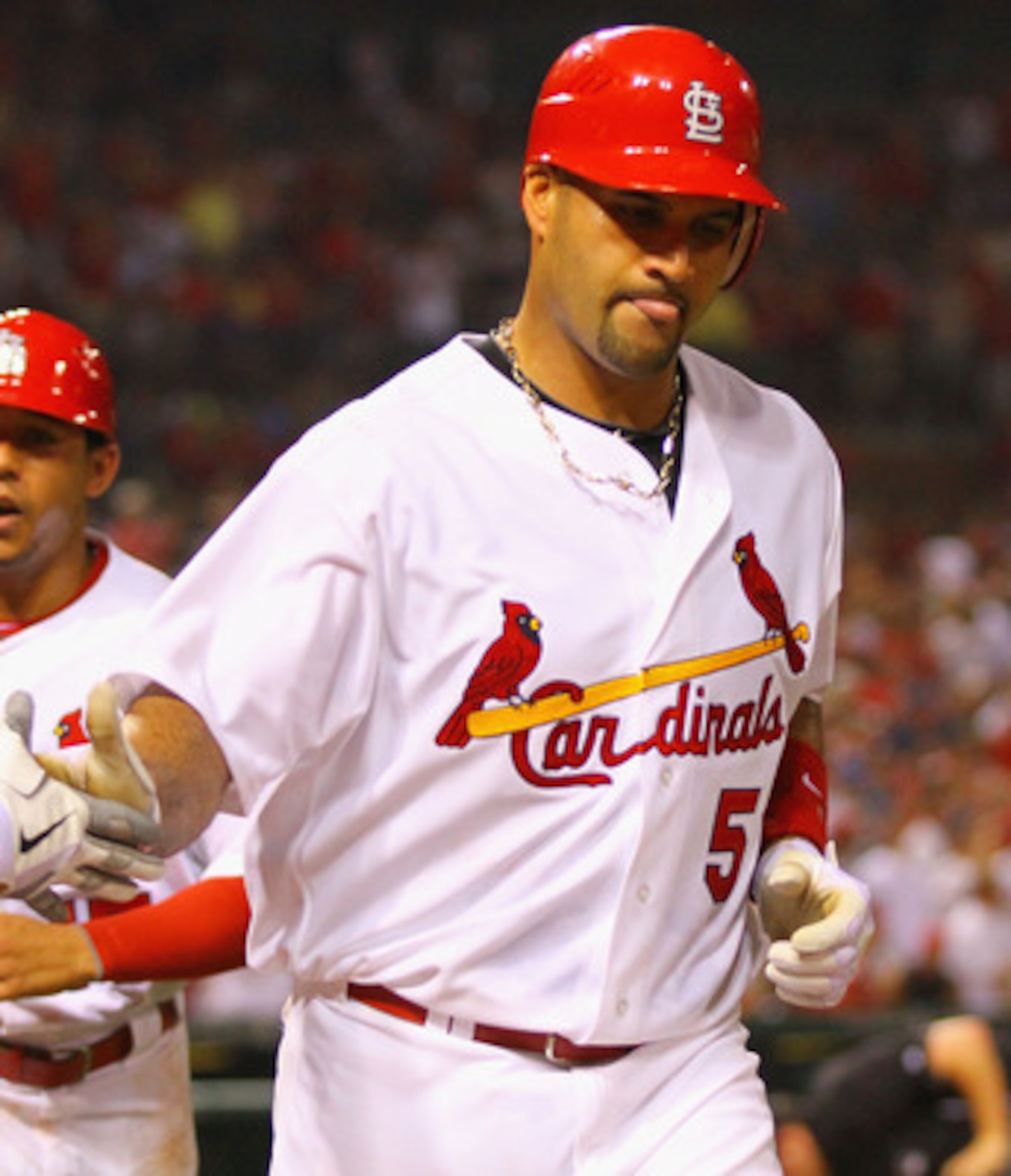 ST. LOUIS, MO - JUNE 3: Albert Pujols #5 of the St. Louis Cardinals celebrates after hitting a two-run home run against the Chicago Cubs at Busch Stadium on June 3, 2011 in St. Louis, Missouri.  (Photo by Dilip Vishwanat/Getty Images)