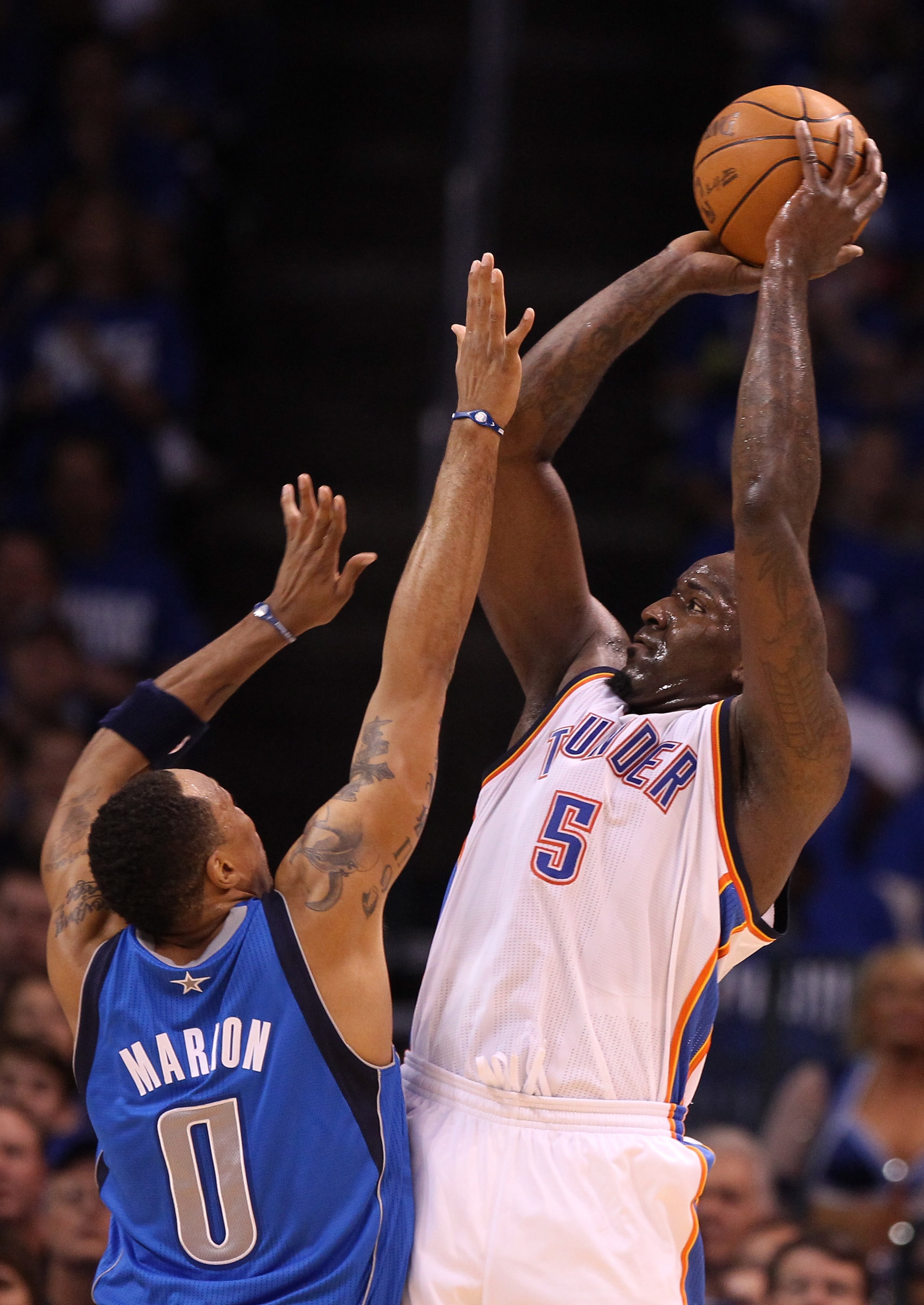 OKLAHOMA CITY, OK - MAY 21:  Kendrick Perkins #5 of the Oklahoma City Thunder shoots over Shawn Marion #0 of the Dallas Mavericks in the first quarter in Game Three of the Western Conference Finals during the 2011 NBA Playoffs at Oklahoma City Arena on Ma