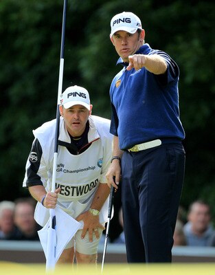 VIRGINIA WATER, ENGLAND - MAY 29:  Lee Westwood of England and Caddy Billy Foster line up a putt during the final round of the BMW PGA Championship  at the Wentworth Club on May 29, 2011 in Virginia Water, England.  (Photo by David Cannon/Getty Images)