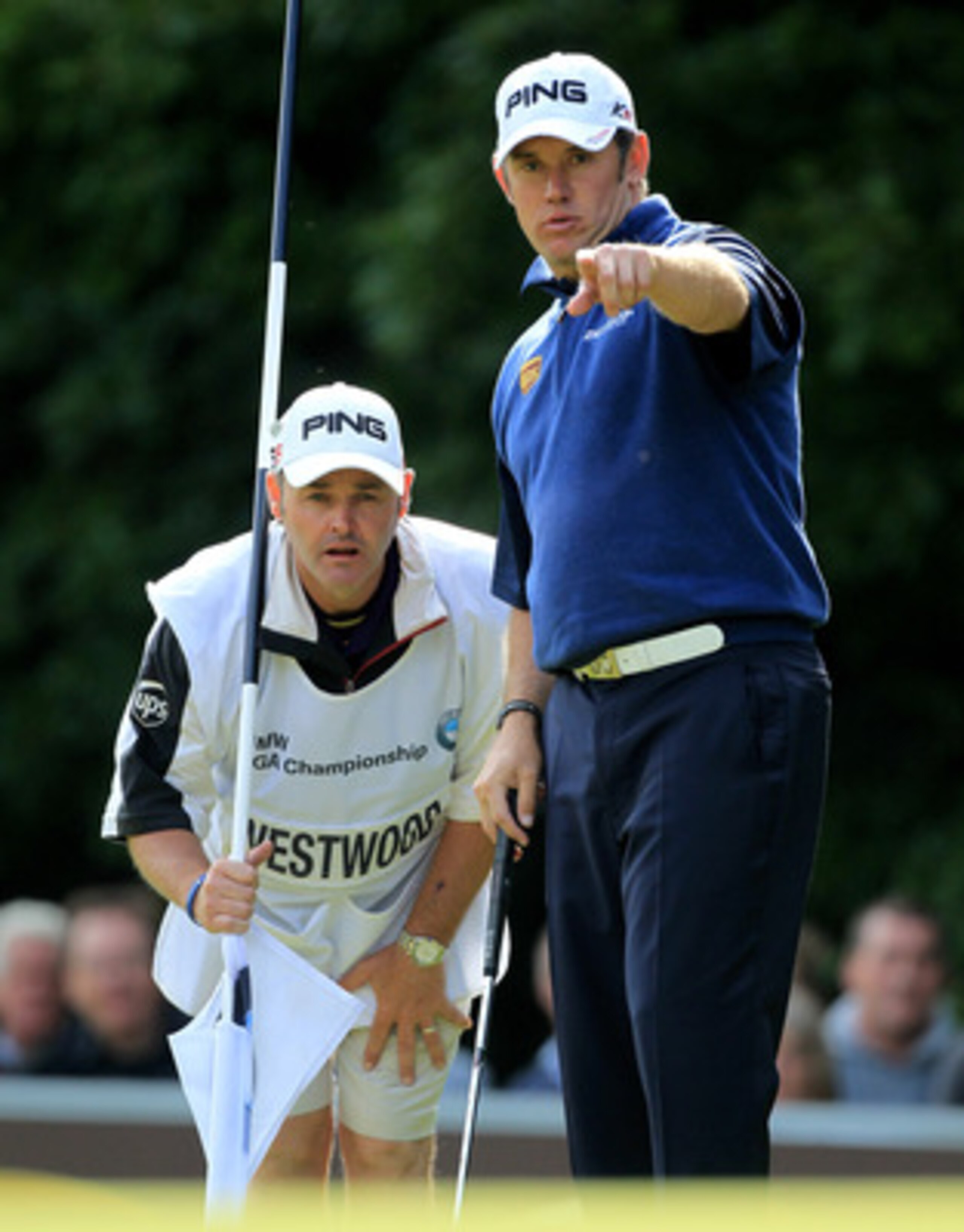VIRGINIA WATER, ENGLAND - MAY 29:  Lee Westwood of England and Caddy Billy Foster line up a putt during the final round of the BMW PGA Championship  at the Wentworth Club on May 29, 2011 in Virginia Water, England.  (Photo by David Cannon/Getty Images)