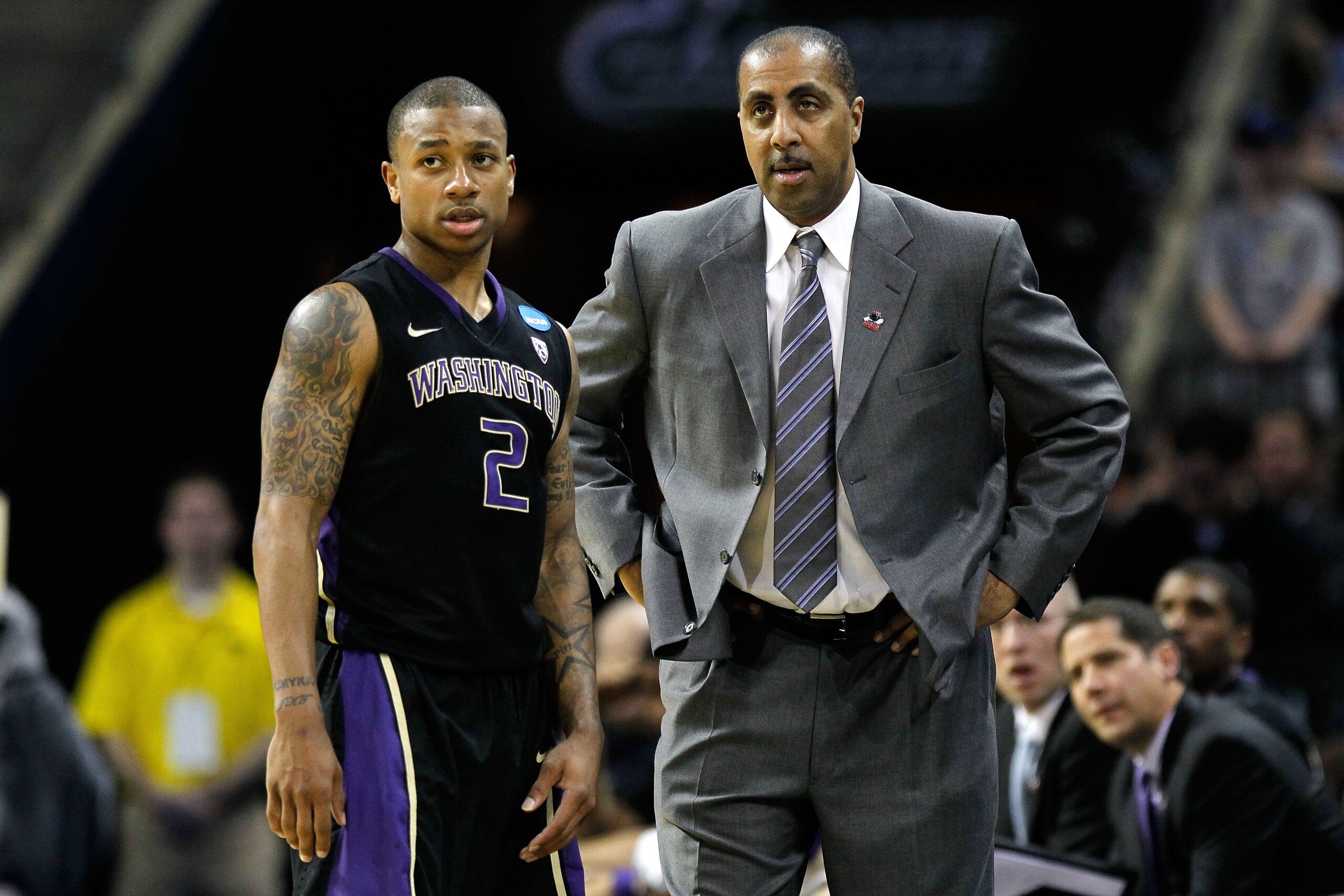 CHARLOTTE, NC - MARCH 20:  Isaiah Thomas #2 talks with head coach Lorenzo Romar of the Washington Huskies while taking on the North Carolina Tar Heels during the third round of the 2011 NCAA men's basketball tournament at Time Warner Cable Arena on March