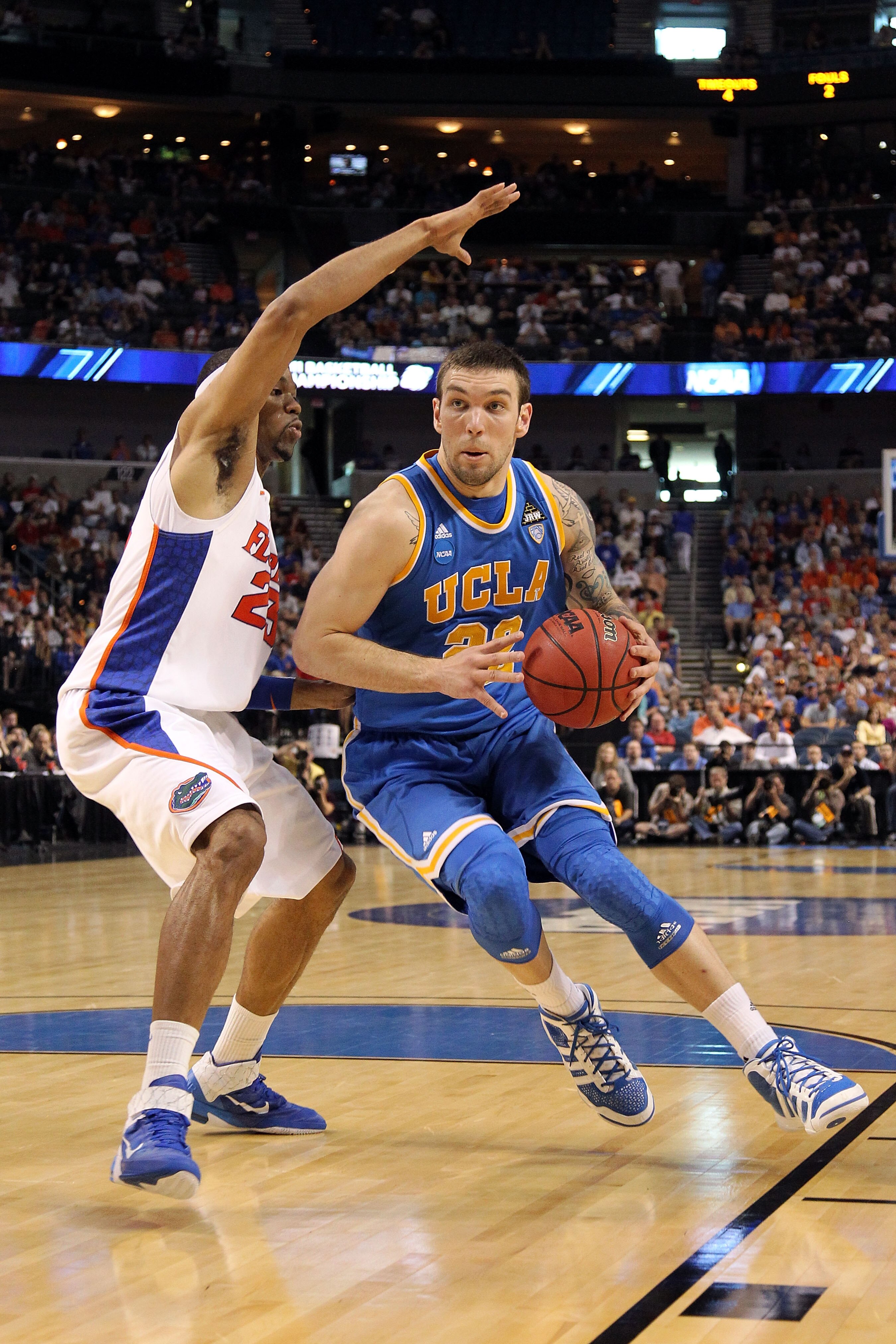 TAMPA, FL - MARCH 19:  Reeves Nelson #22 of the UCLA Bruins drives against Alex Tyus #23 of the Florida Gators during the third round of the 2011 NCAA men's basketball tournament at St. Pete Times Forum on March 19, 2011 in Tampa, Florida. Florida won 73-