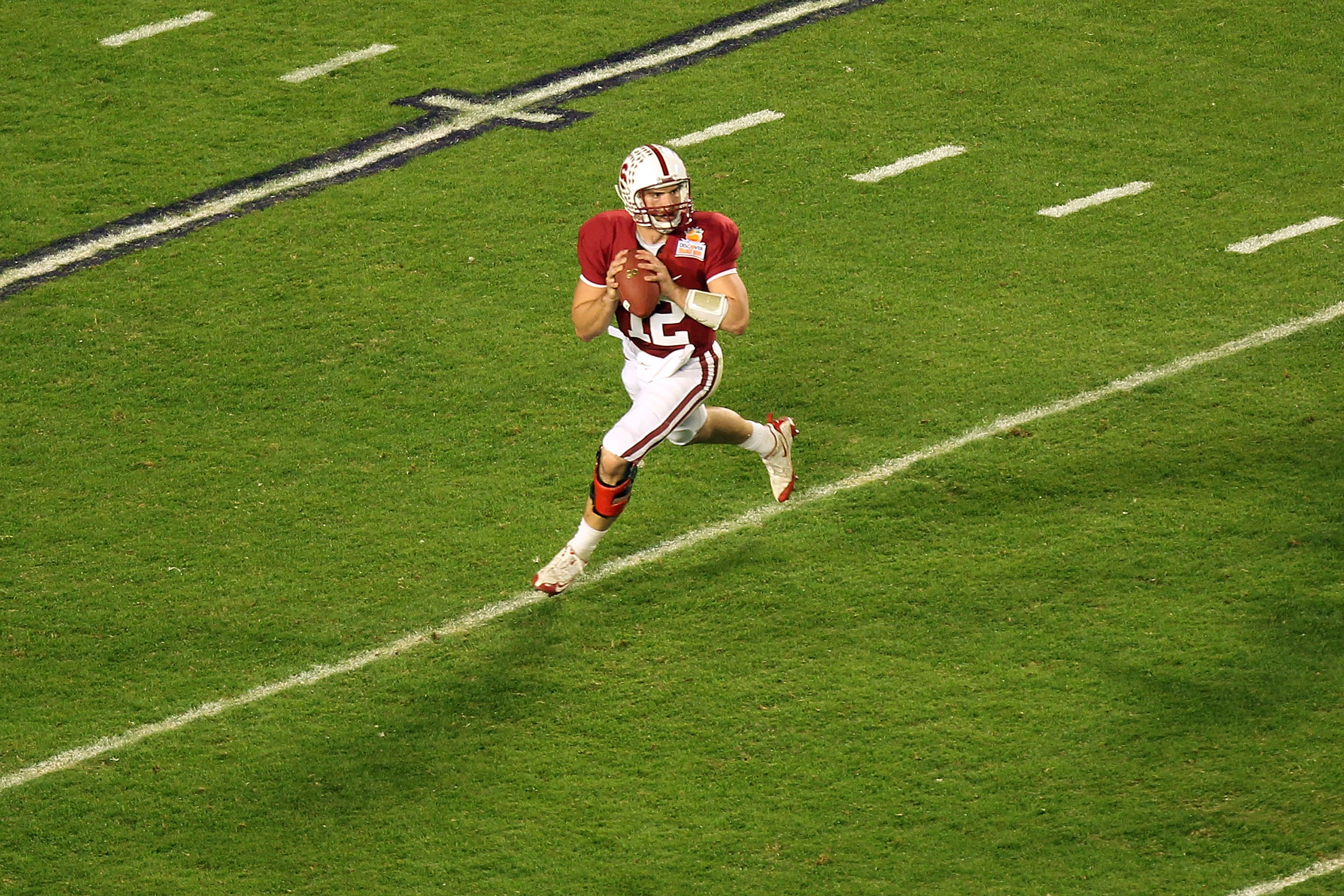 MIAMI, FL - JANUARY 03:  Quarterback Andrew Luck #12 of the Stanford Cardinal looks to pass as he rolls out of the pocket against the Virginia Tech Hokies during the 2011 Discover Orange Bowl at Sun Life Stadium on January 3, 2011 in Miami, Florida. Stanf