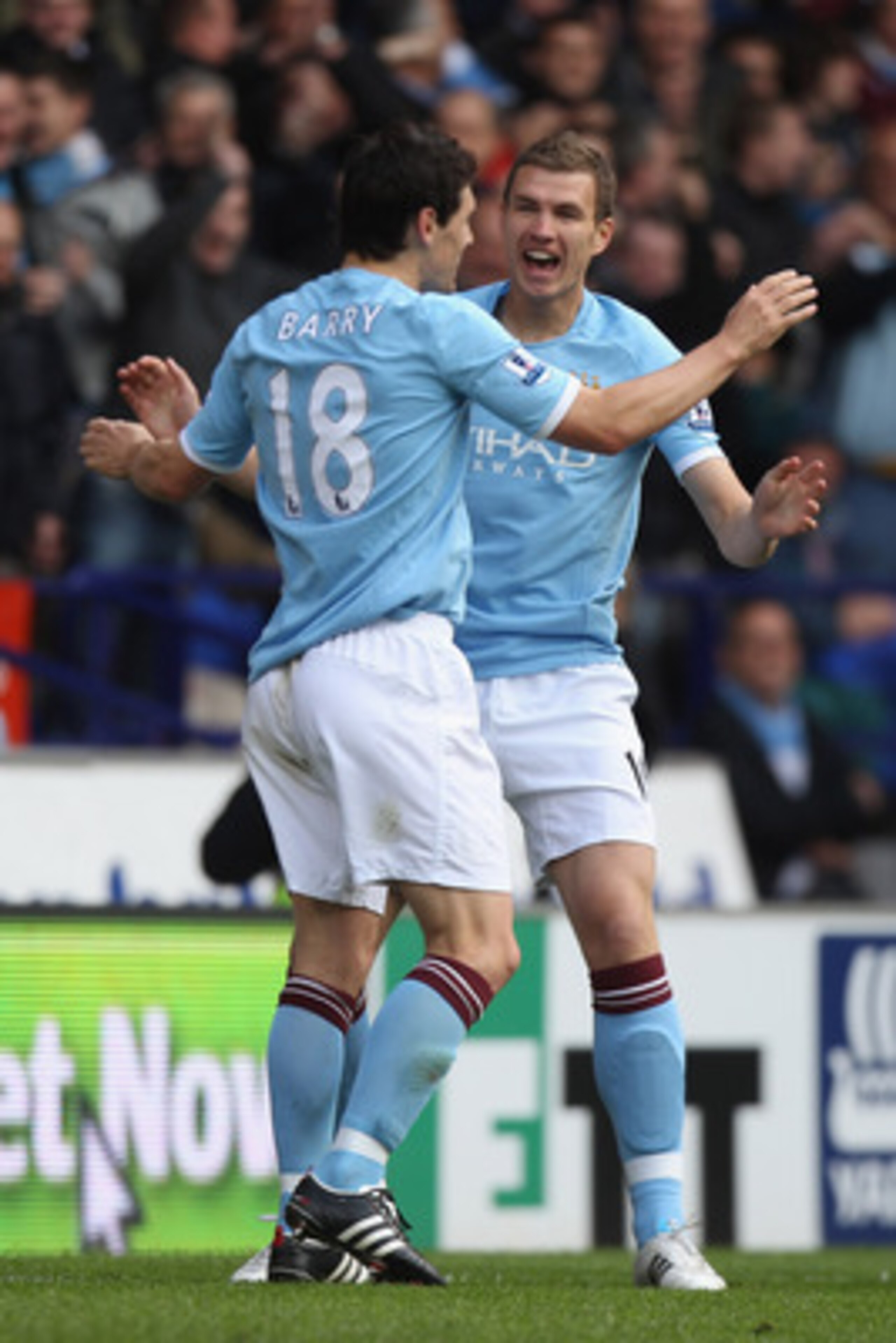 BOLTON, ENGLAND - MAY 22:  Edin Dzeko (R) of Manchester City celebrates scoring the second goal with Gareth Barry (L) during the Barclays Premier League match between  Bolton Wanderers and Manchester City at the Reebok Stadium on May 22, 2011 in Bolton, E
