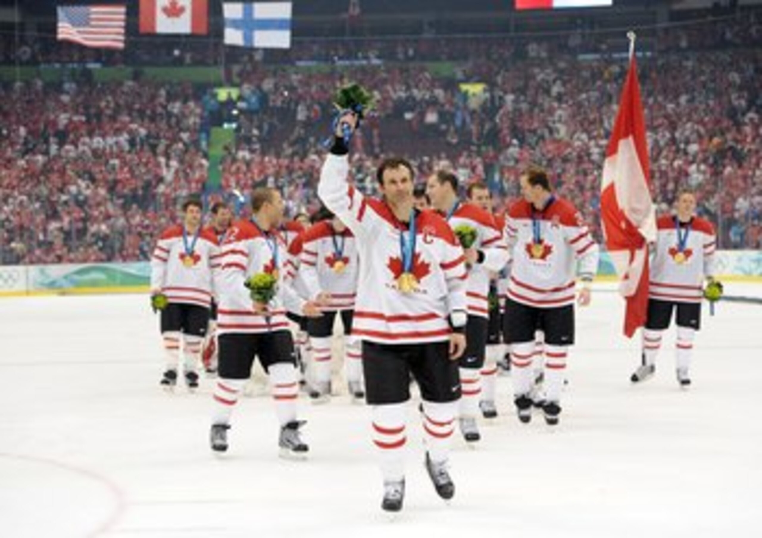VANCOUVER, BC - FEBRUARY 28:  Team Captain Scott Niedermayer #27 of Canada waves to the fans after receiving the gold medal following his team's 3-2 overtime victory in the ice hockey men's gold medal game against USA on day 17 of the Vancouver 2010 Winte