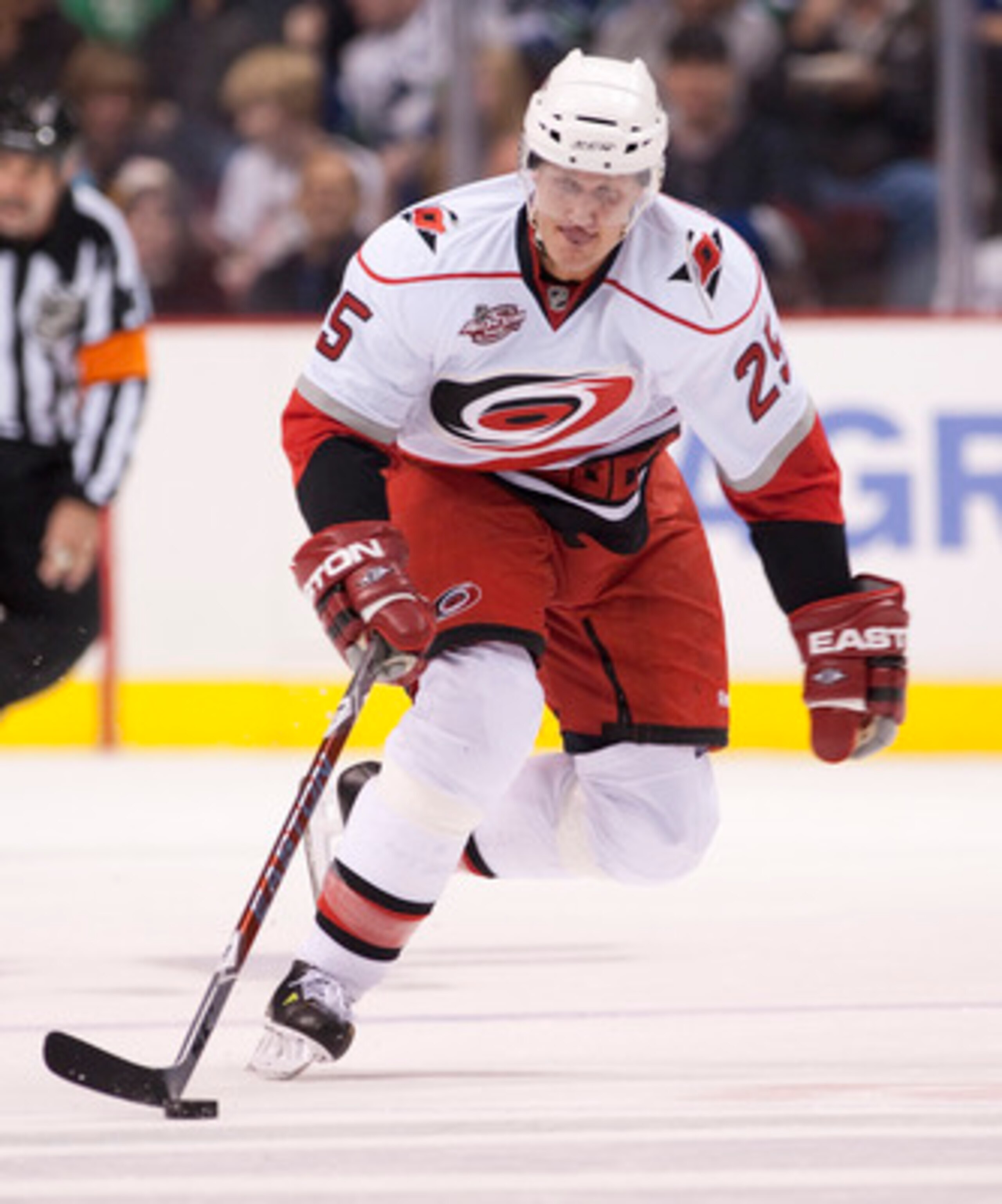 VANCOUVER, CANADA - OCTOBER 17: Joni Pitkanen #25 of the Carolina Hurricanes skates with the puck up ice during NHL action against the Vancouver Canucks on October 17, 2010 at Rogers Arena in Vancouver, British Columbia, Canada.  (Photo by Rich Lam/Getty 