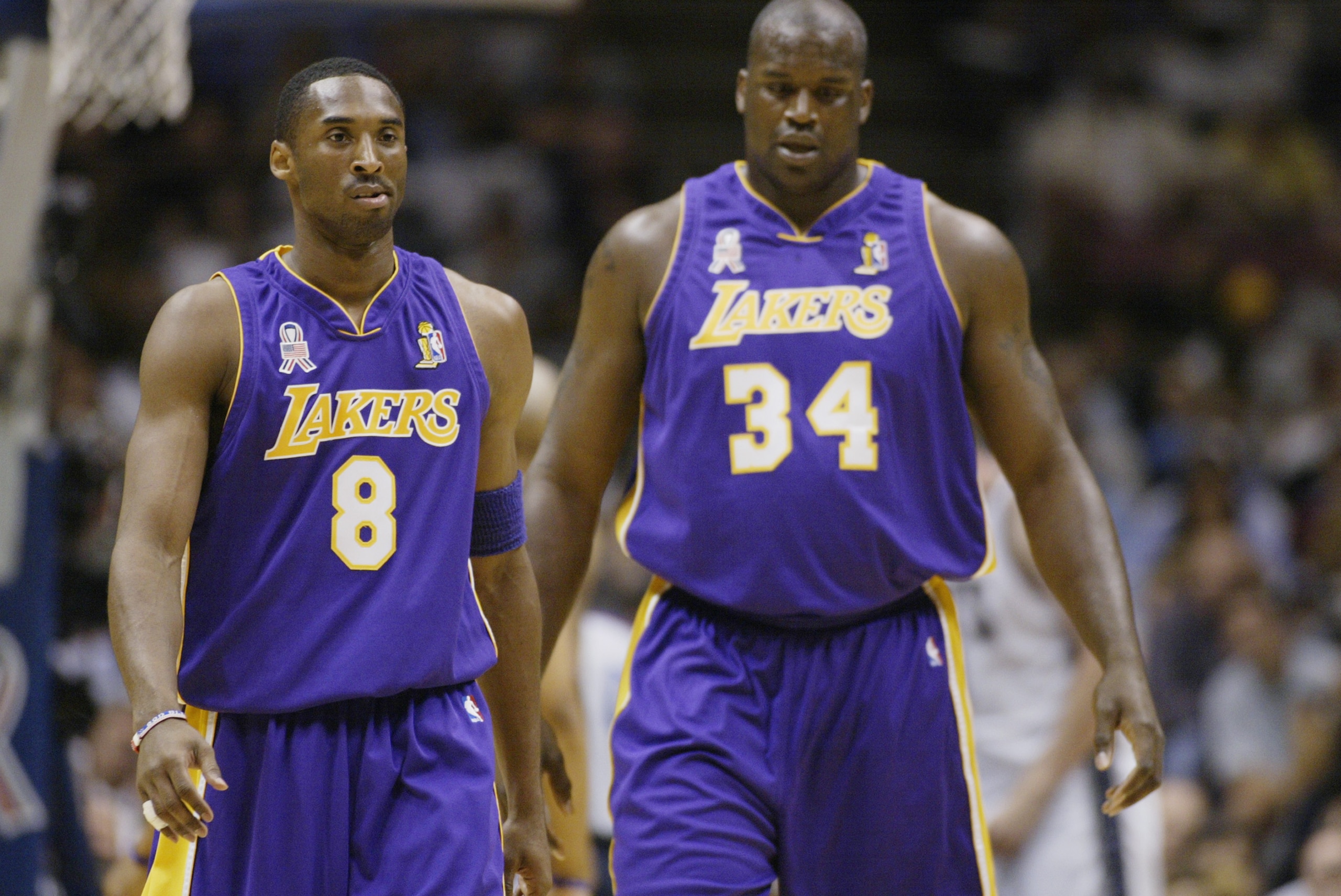 EAST RUTHERFORD, NJ - JUNE 12:  Kobe Bryant #8 and Shaquille O'Neal #34 of the Los Angeles Lakers walk upcourt in Game four of the 2002 NBA Finals against the New Jersey Nets on June 12, 2002 at Continental Airlines Arena in East Rutherford, New Jersey. T