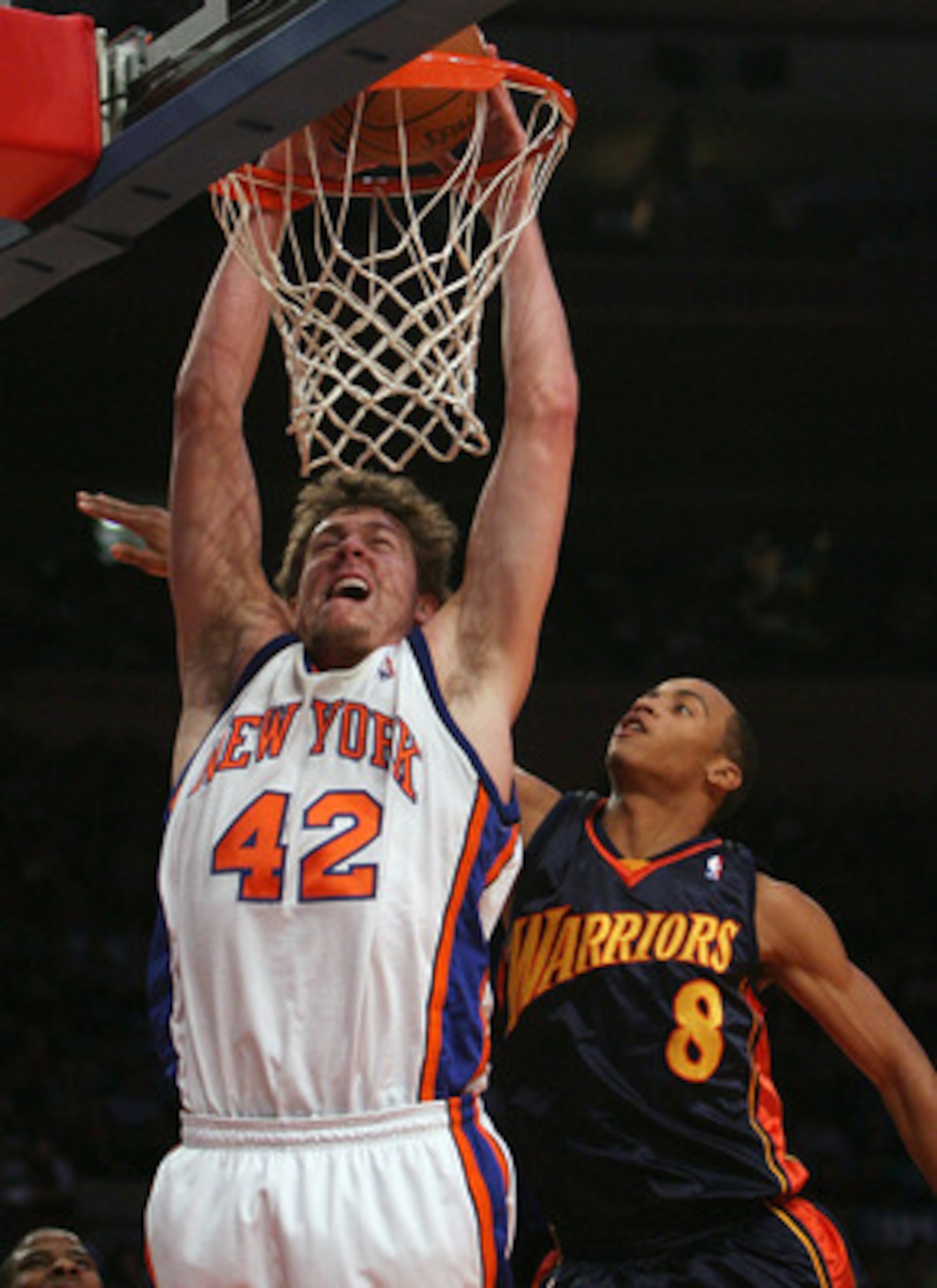 NEW YORK - NOVEMBER 20: David Lee #42 of the New York Knicks dunks the ball despite the block attempt from Monta Ellis #8 of Golden State Warriors at Madison Square Garden on November 20, 2007 in New York City.  NOTE TO USER: User expressly acknowledges a