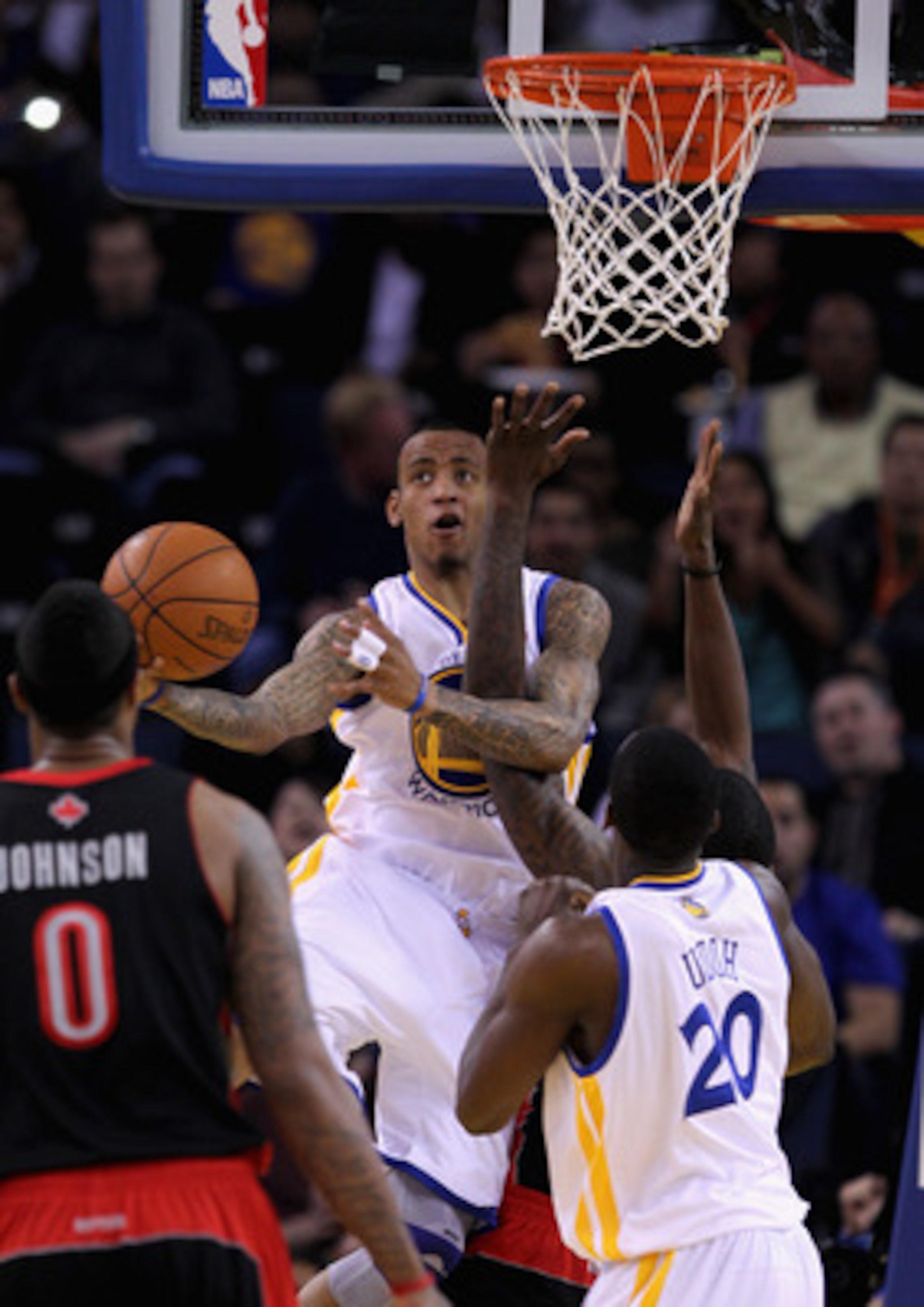 OAKLAND, CA - MARCH 25: Monta Ellis #8 of the Golden State Warriors is fouled while going up for a shot against the Toronto Raptors at Oracle Arena on March 25, 2011 in Oakland, California. NOTE TO USER: User expressly acknowledges and agrees that, by dow